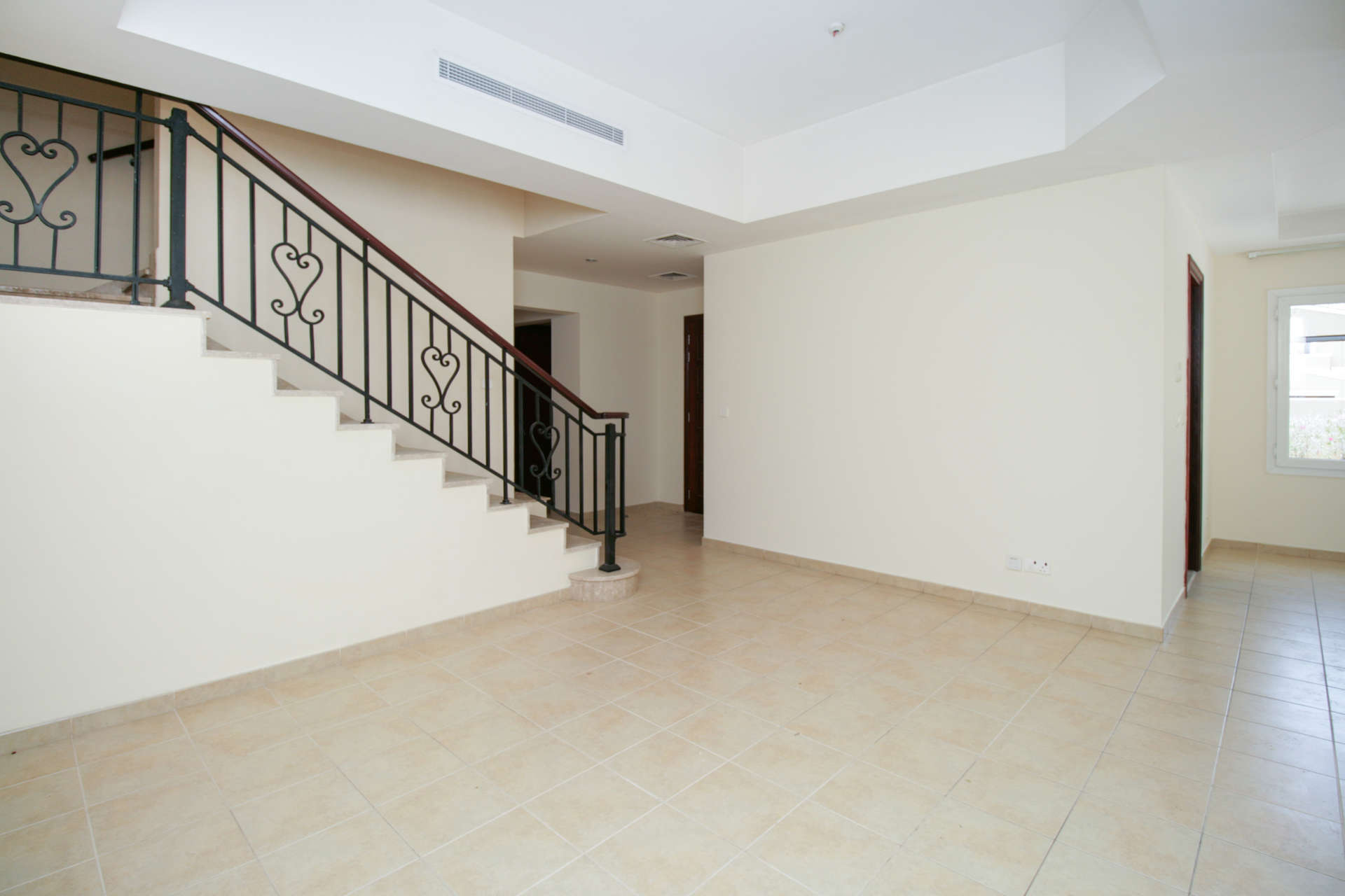 Spacious living area with staircase in Palmera Villa, Arabian Ranches, for rent