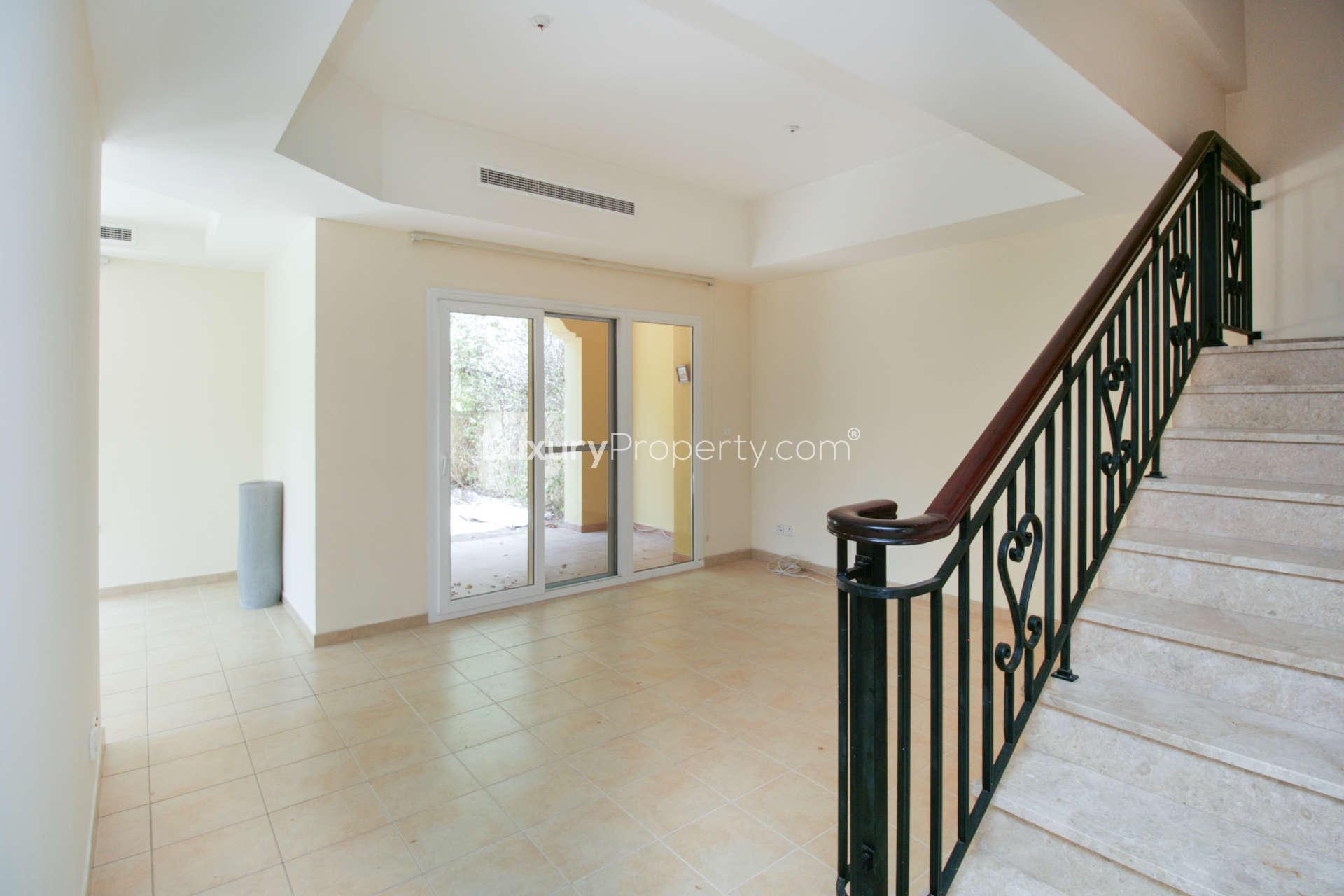 Spacious 3-bedroom Palmera villa exterior in Arabian Ranches for rent, featuring garage and driveway