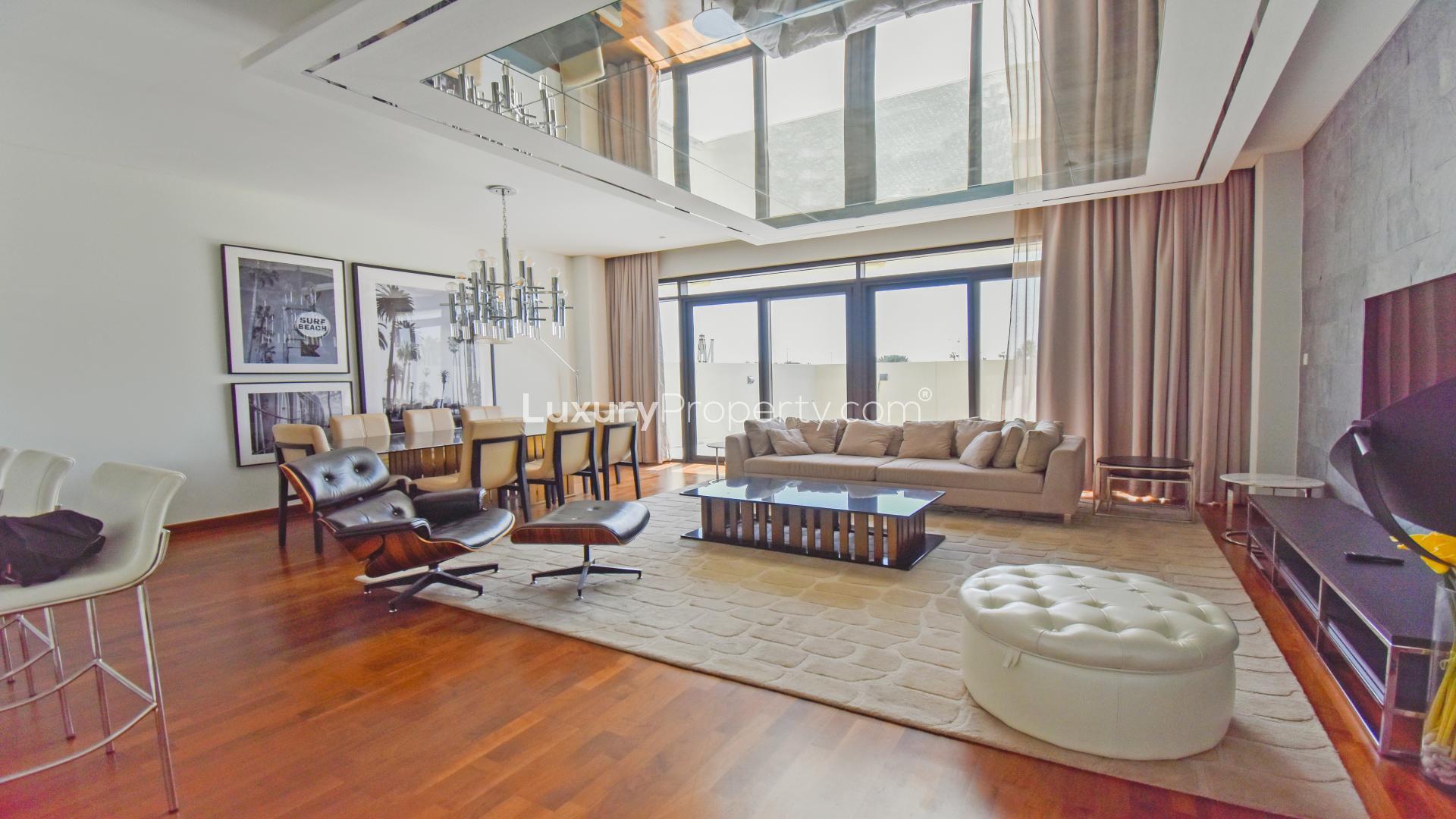 "Modern three-bedroom villa exterior in Picadilly Green, Damac Hills for rent, fully furnished.",Luxurious living room in fully furnished villa, Damac Hills, Picadilly Green, with modern decor