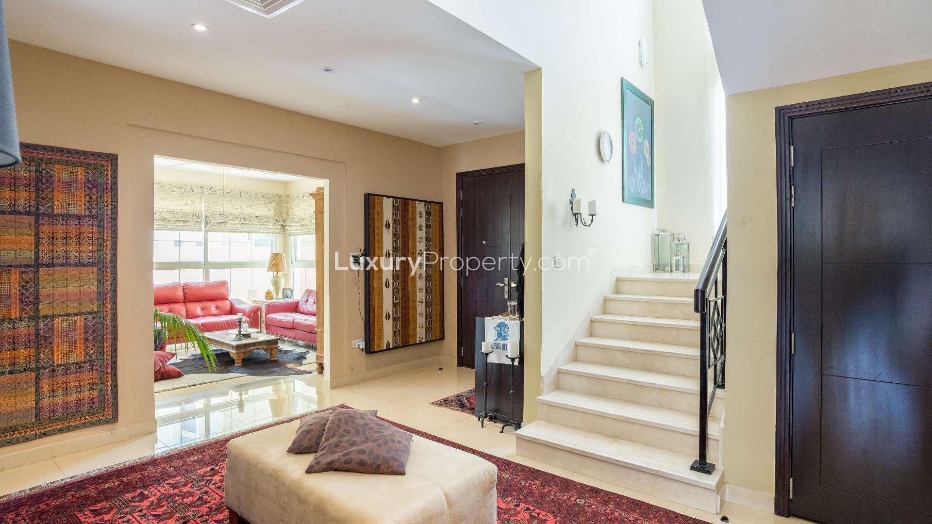 Exterior view of spacious villa in Rahat, Mudon with landscaped garden and patio area