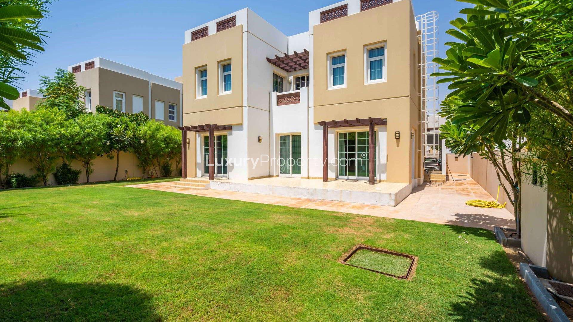 Spacious living room in Rahat villa, Mudon with garden view, modern decor, and natural light