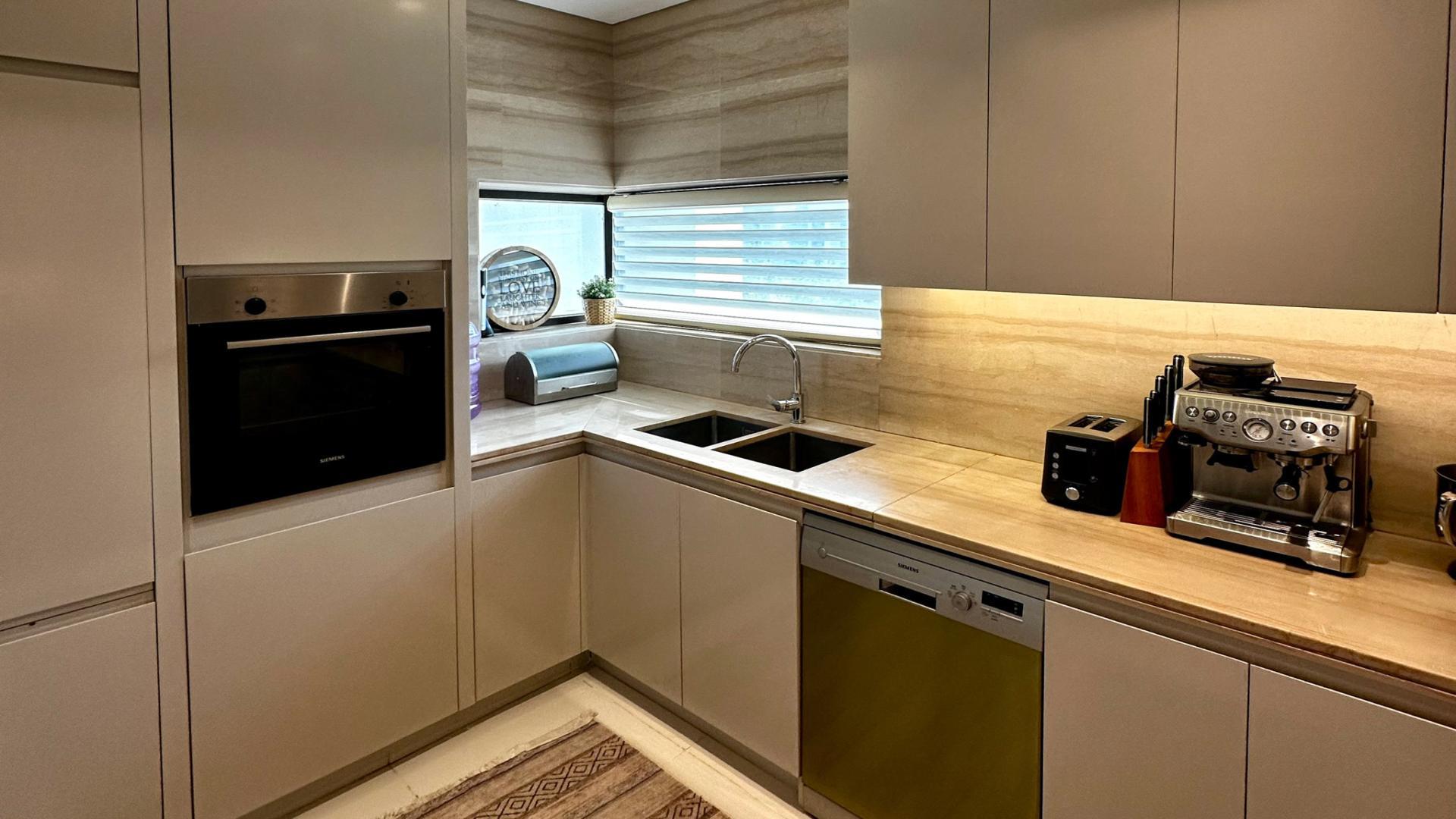 Modern kitchen with luxury finishes in upgraded 3-bedroom townhouse, Veneto Villas, Damac Hills