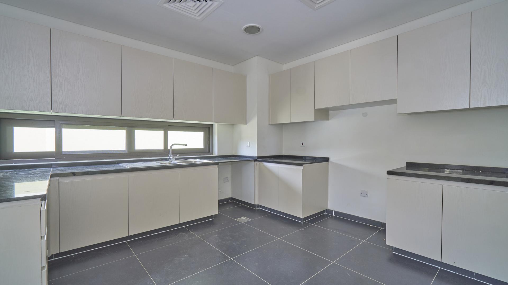 Spacious empty living room in Damac Hills villa, Richmond community, with modern ceiling design