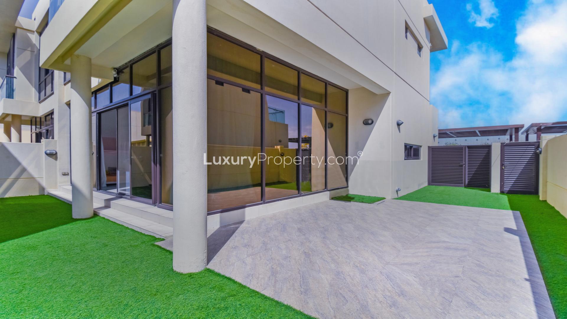 Luxurious living room in Damac Hills villa with modern decor and large windows