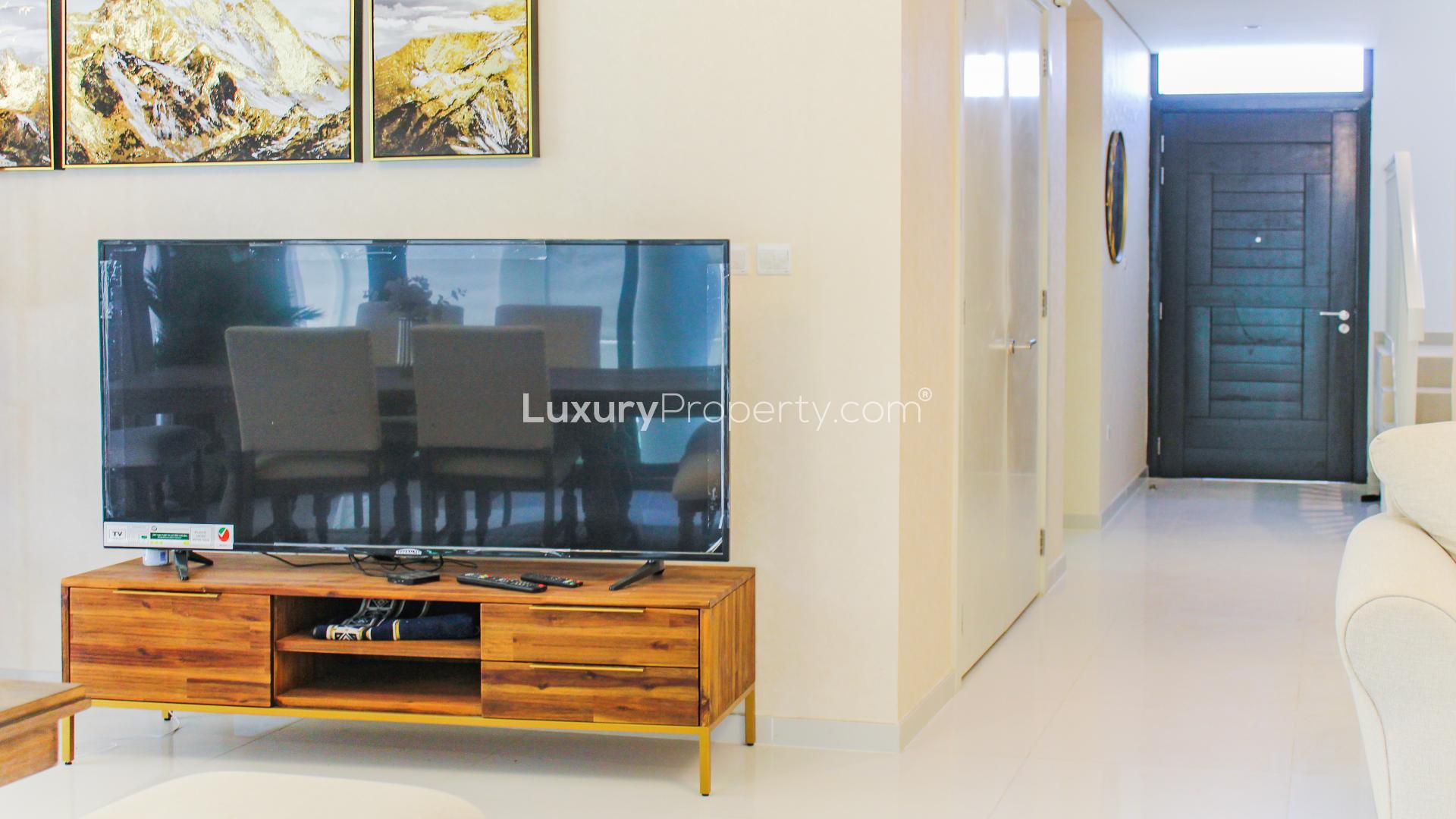 Elegant living room with garden view in Damac Hills villa, Rochester community