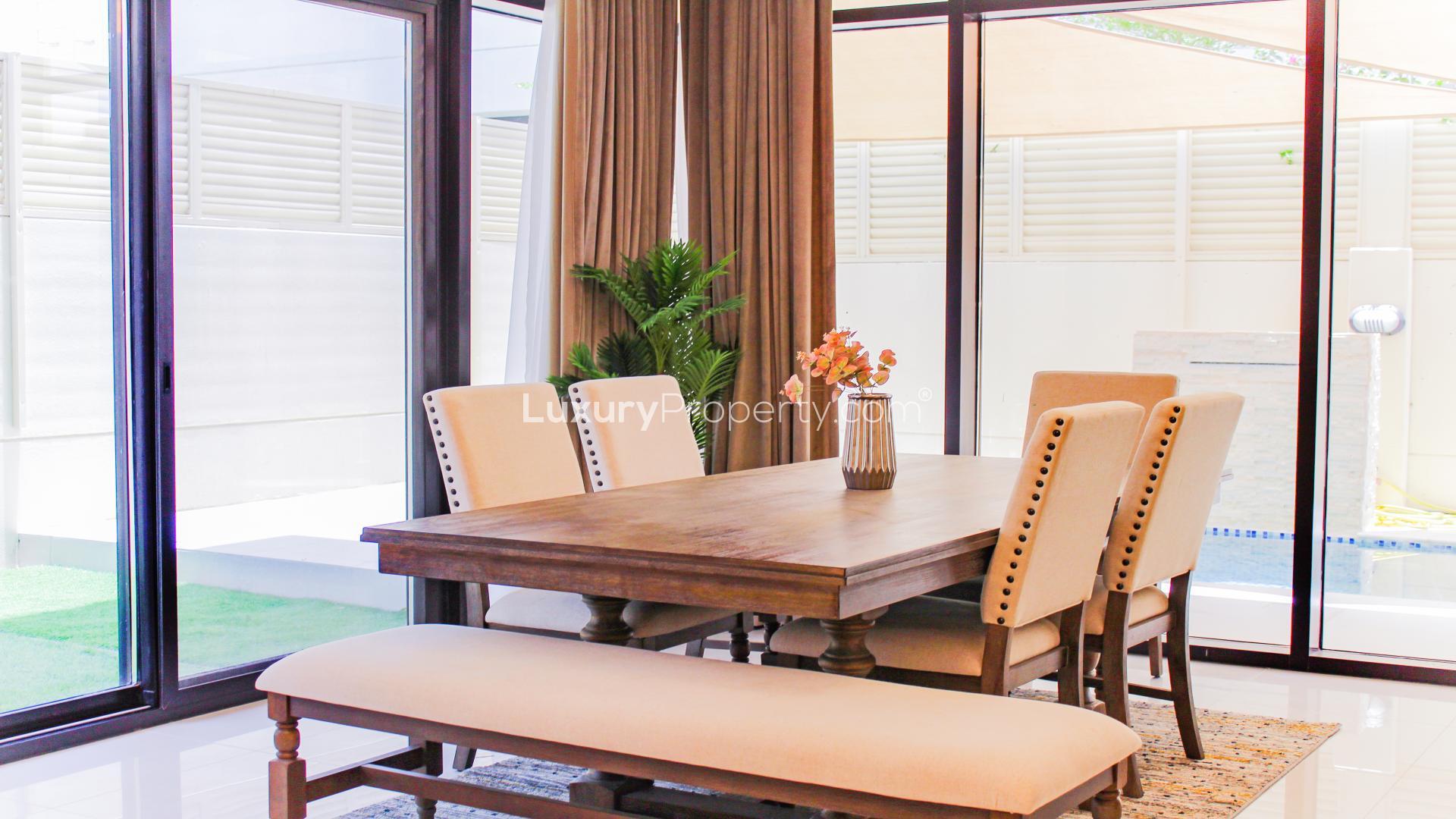 Living area with modern TV unit in Damac Hills villa, Rochester community