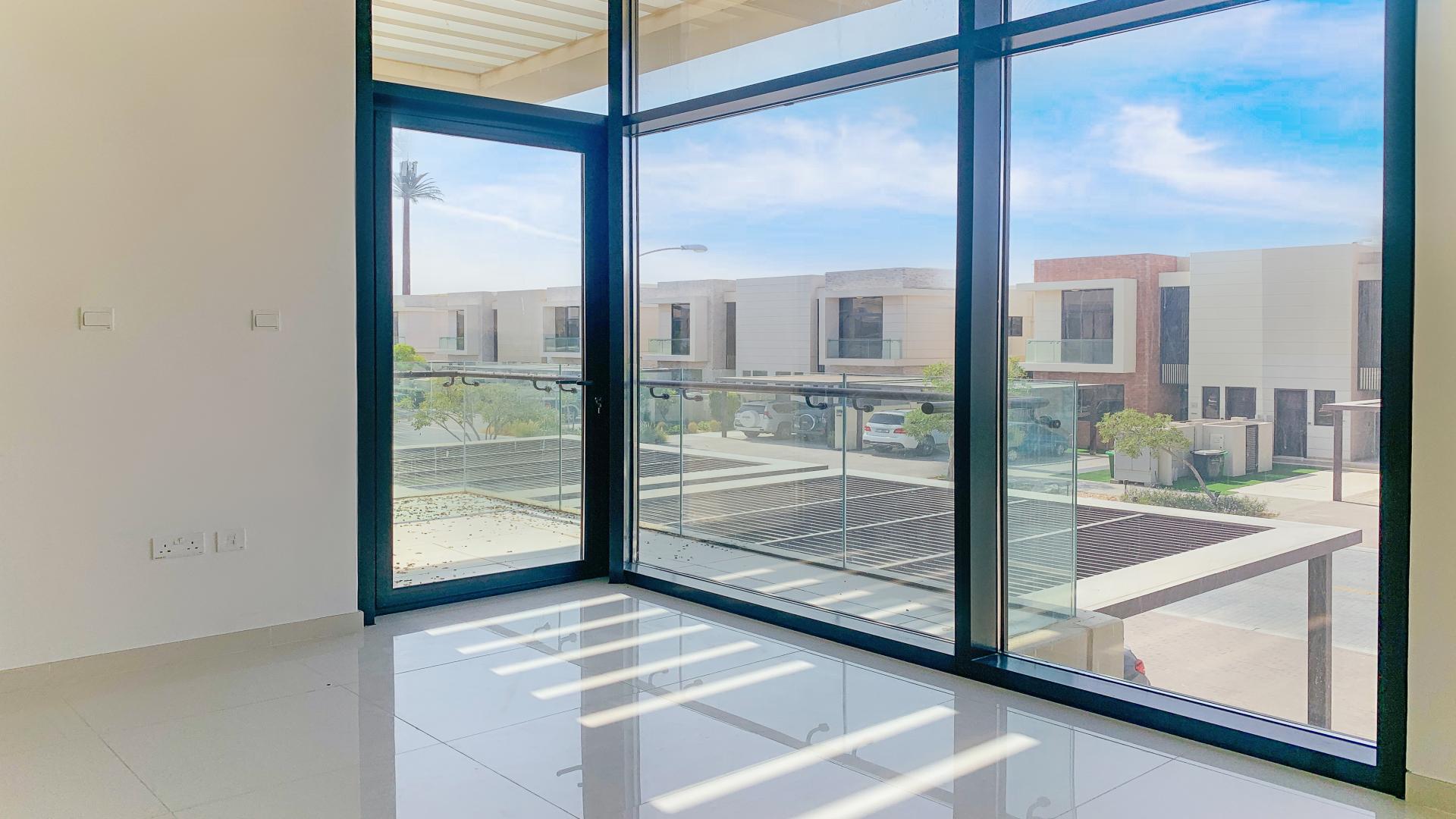 Modern bathroom in Damac Hills villa, featuring sleek sink and toilet design