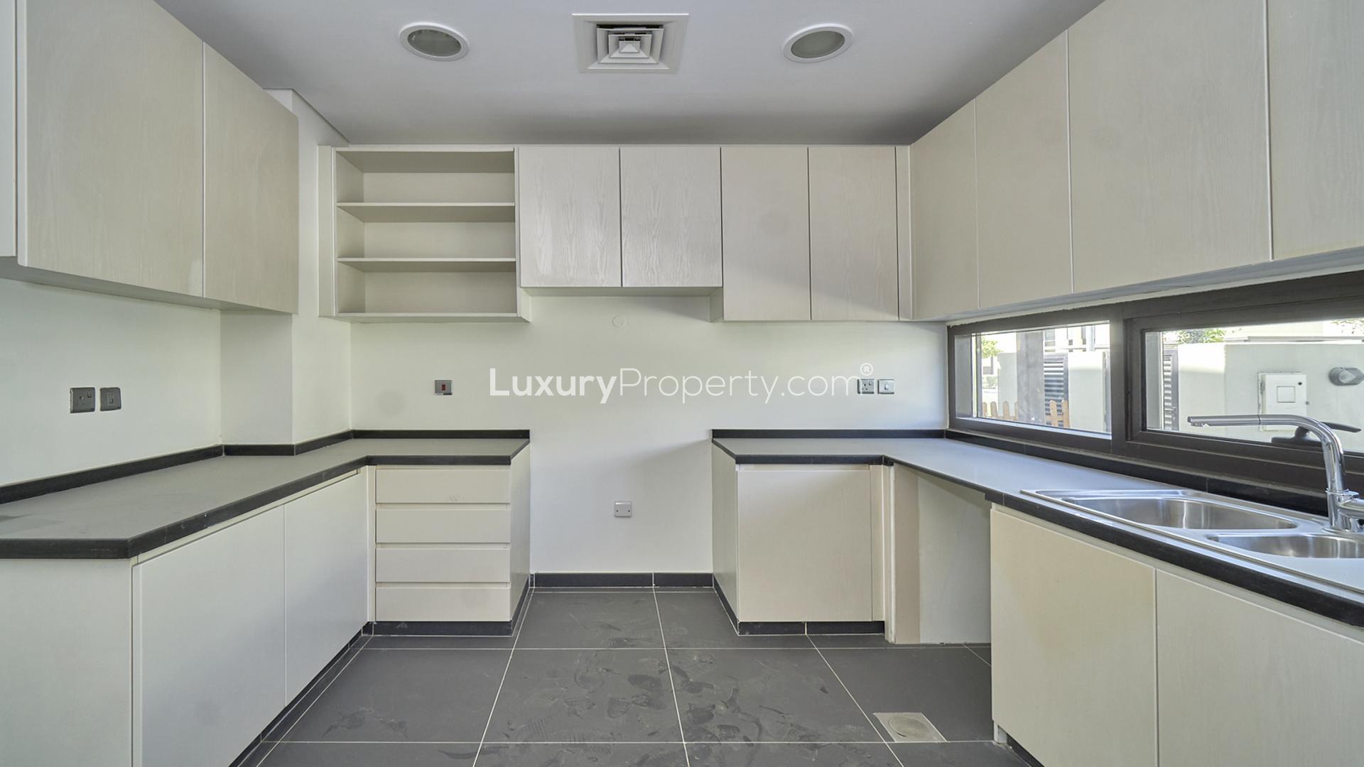 Bright living room with large windows in Damac Hills villa, Rochester sub-community