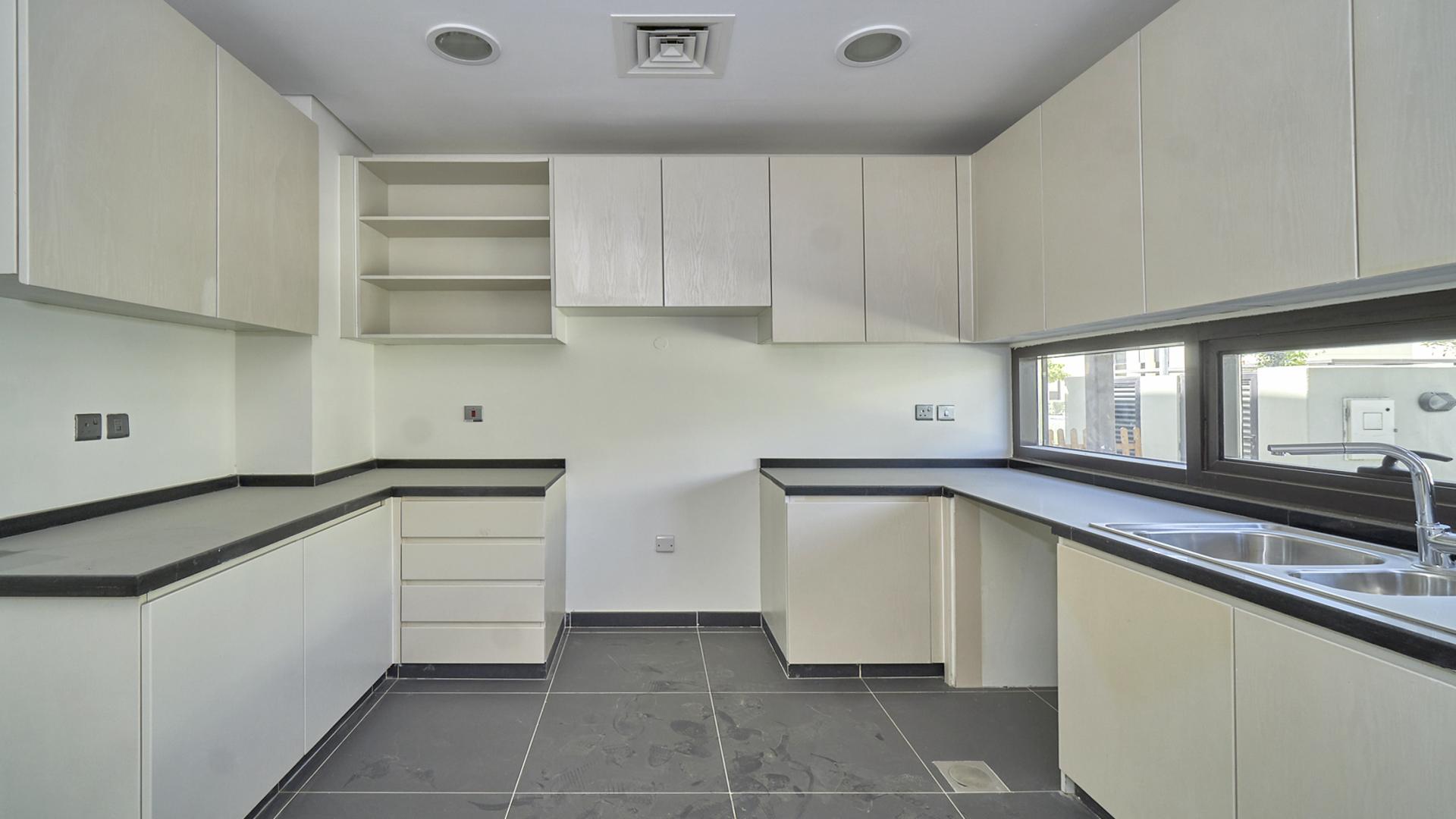 Bright living room with large windows in Damac Hills villa, Rochester sub-community