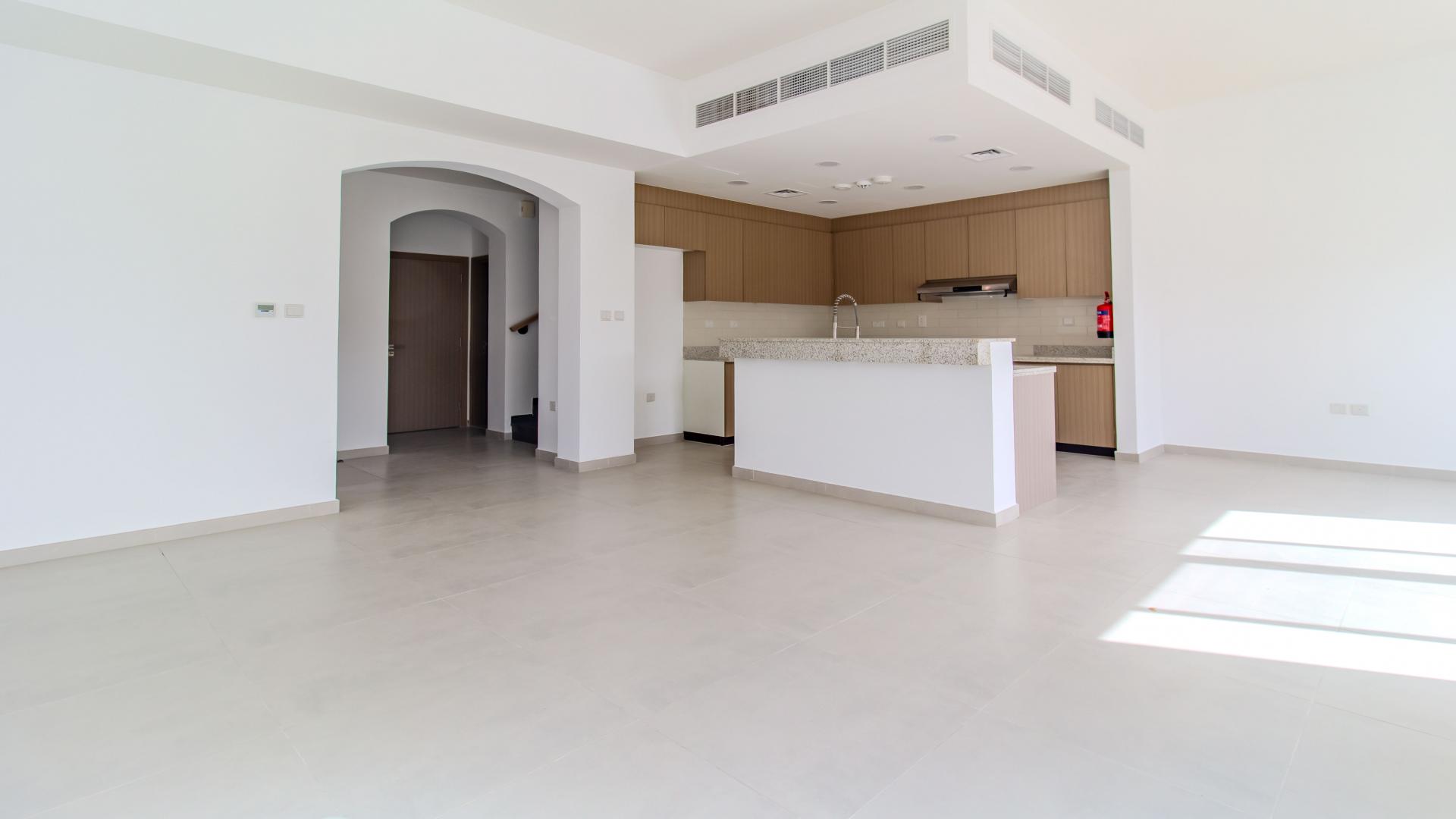 Corner villa patio with green lawn in Amaranta, Villanova, Dubai Land