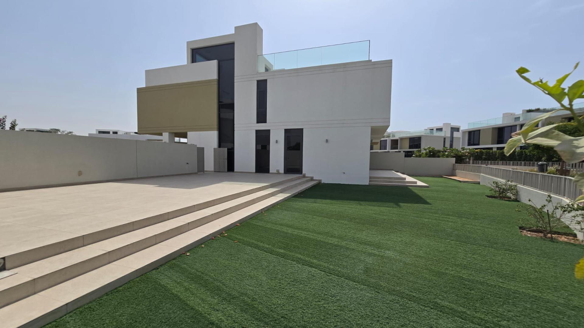 "Modern villa exterior with spacious lawn in Golf Grove