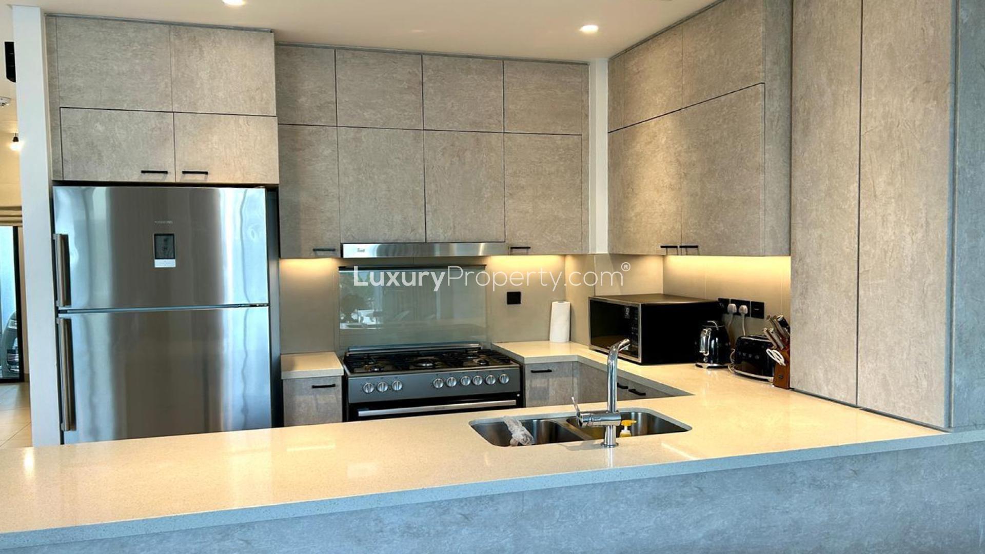 Modern kitchen and living area in furnished Golf Grove Villa, Dubai Hills Estate