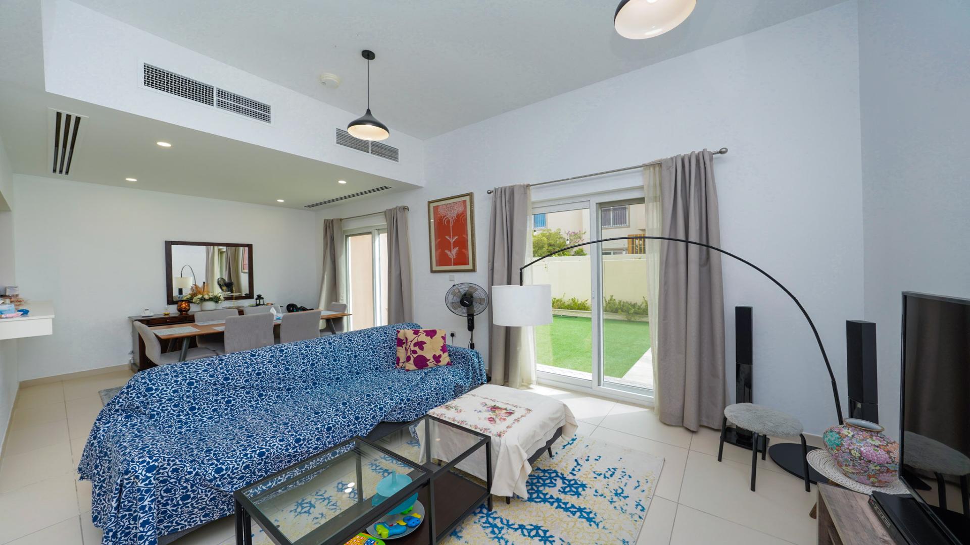 Elegant villa garden with lush lawn in Villanova, Dubai Land for rent