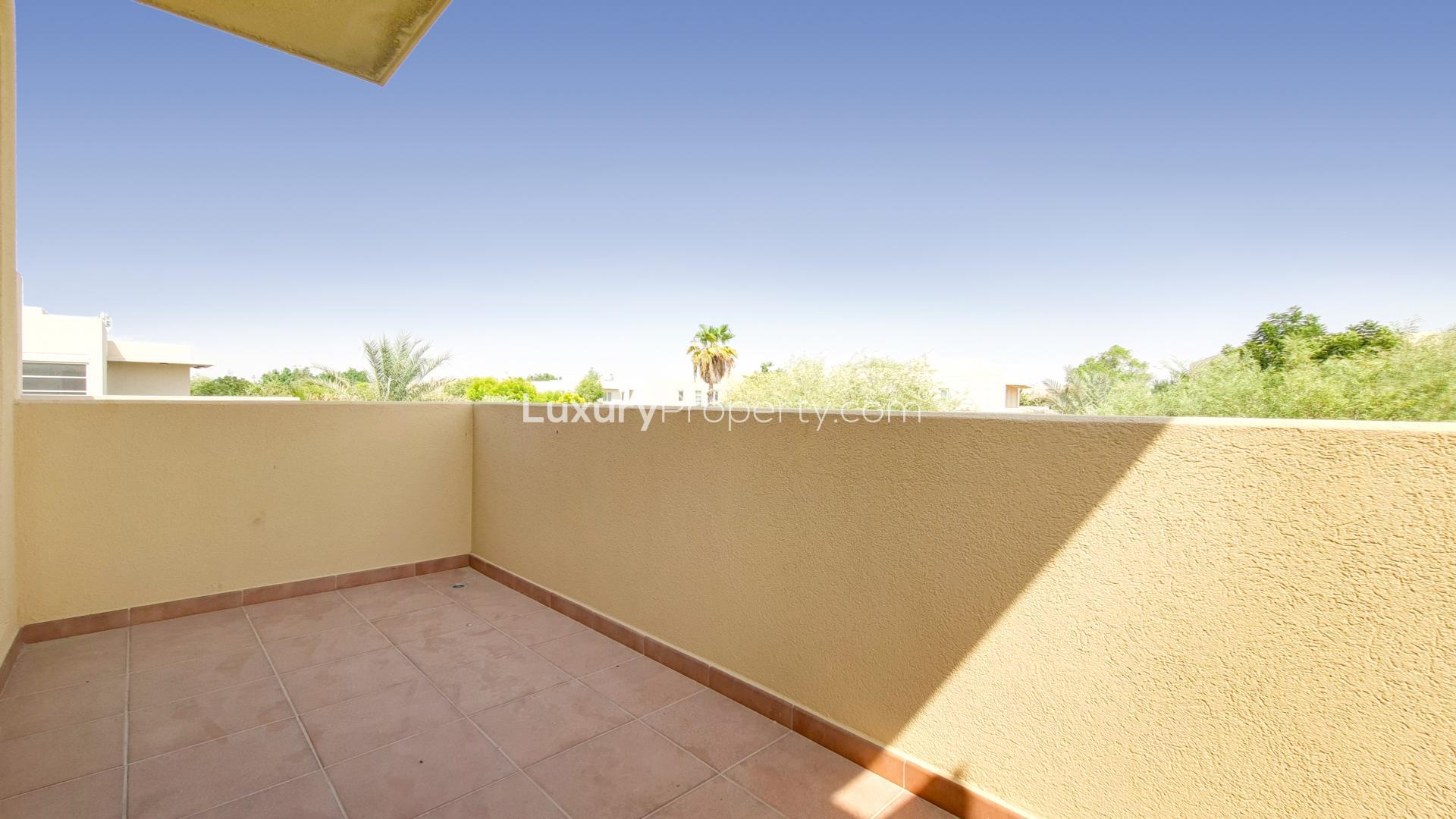 Bright living room with large windows overlooking garden in Saheel villa, Arabian Ranches