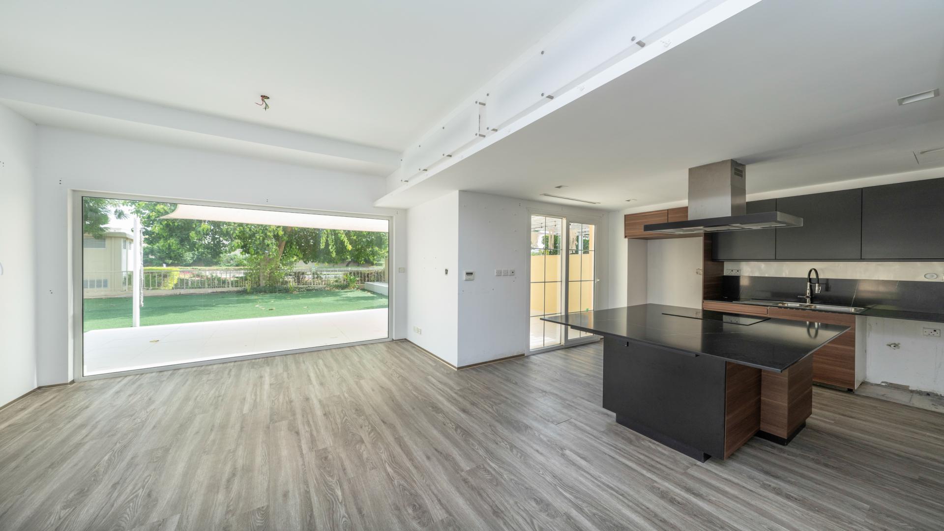 Modern kitchen and living area in Springs 14 villa, featuring sleek wooden flooring