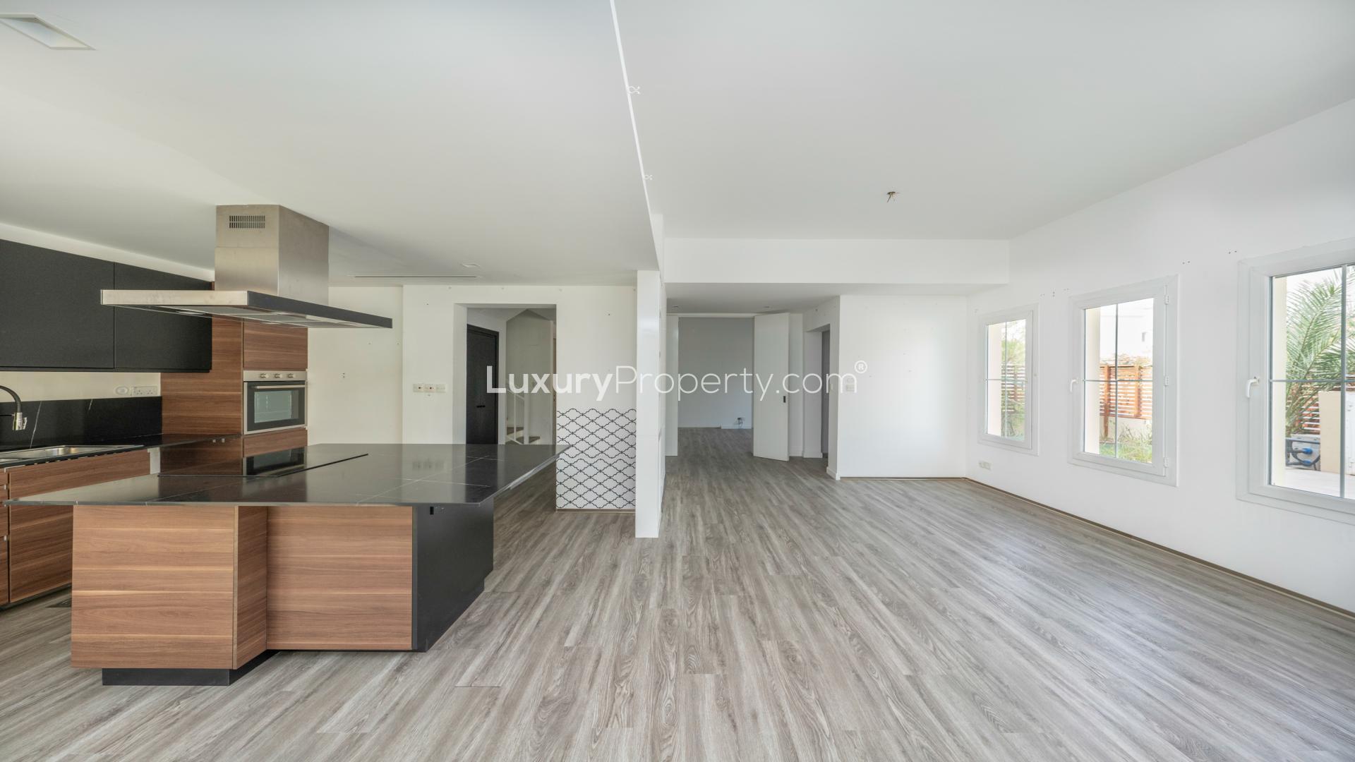 Elegant villa garden with lush greenery overlooking a serene lake in Springs 14