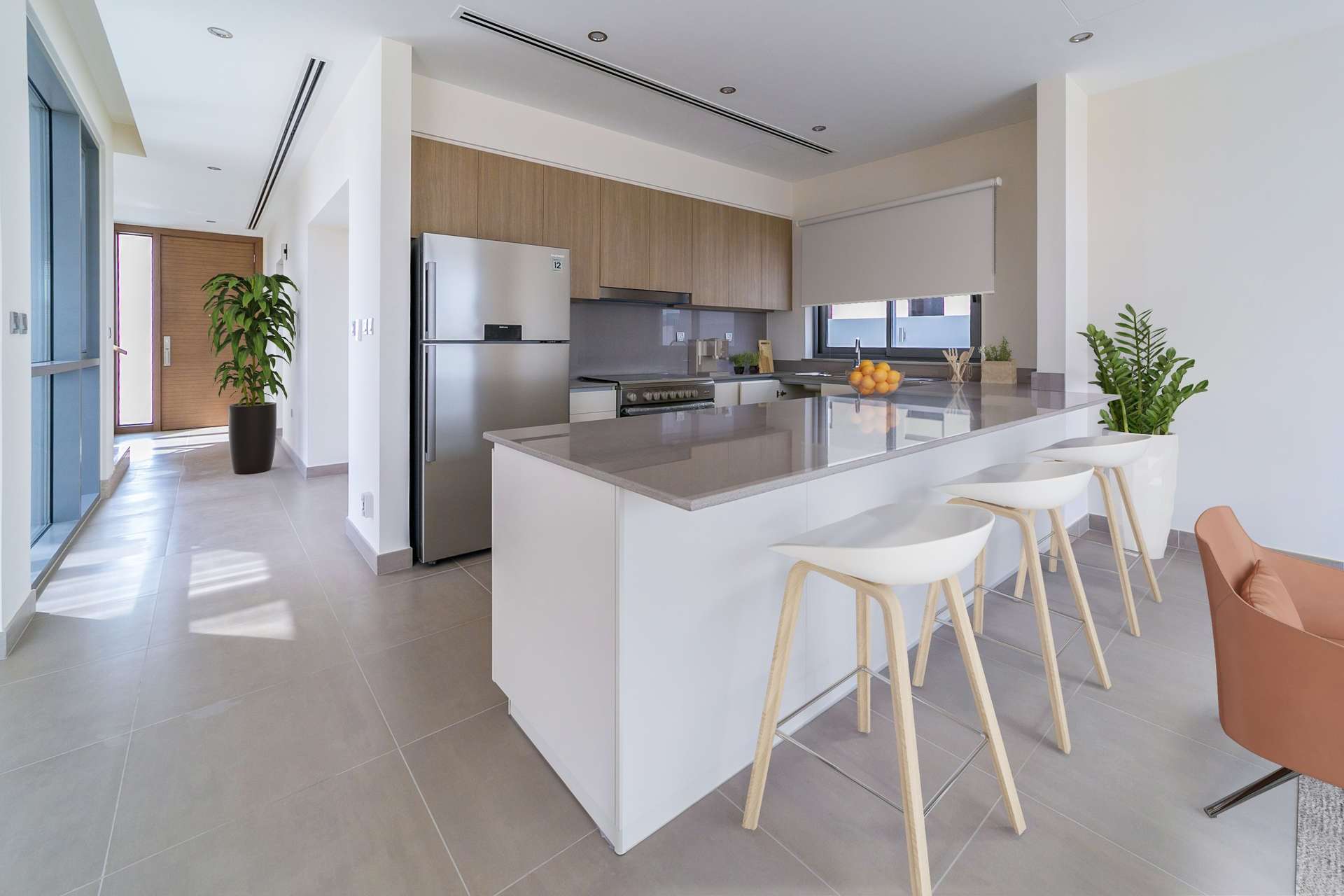 Modern kitchen in 3-bedroom villa, Sidra, Dubai Hills Estate, with sleek countertops and bar stools