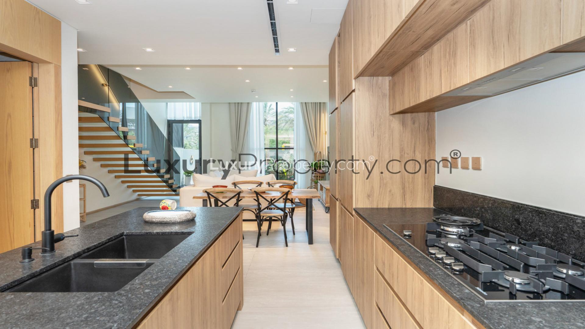 Elegant living room with modern staircase in Jumeirah Village Circle villa for rent