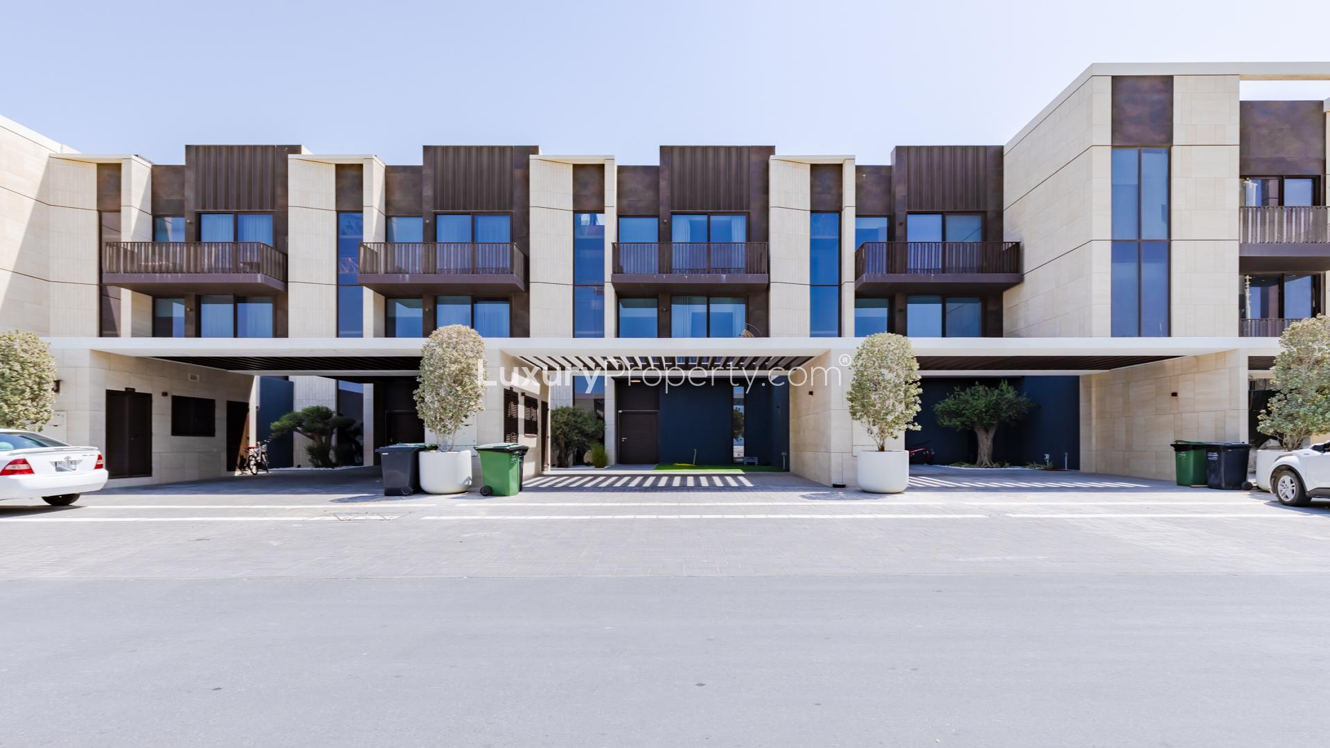 Luxury villa exterior with balconies and garden in Jumeirah Bay Island, Dubai