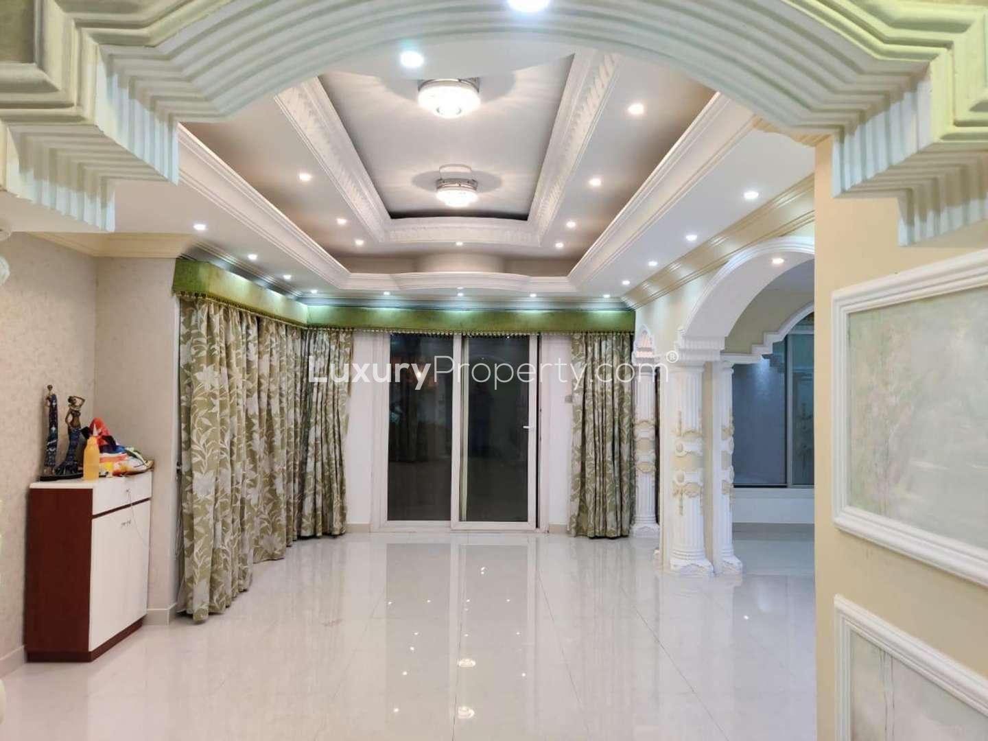 Luxurious living room with elegant ceiling design in Springs 8 villa for rent