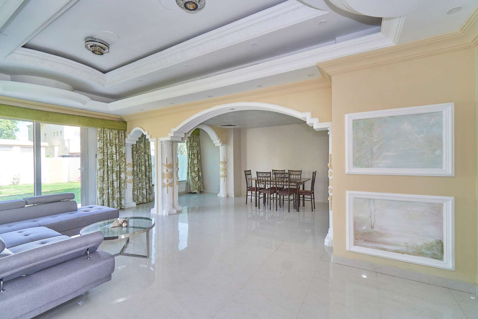 Bright living room in upgraded 3-bedroom villa, Springs 8, featuring elegant archways and decor