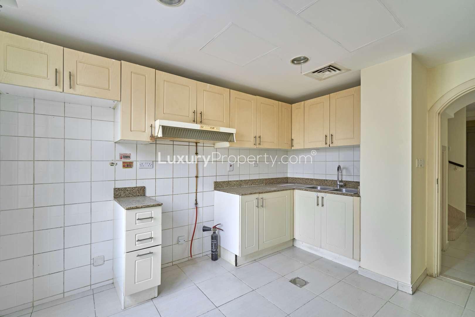 Bright bedroom with tiled floors and balcony access in The Springs villa, Emirates Living