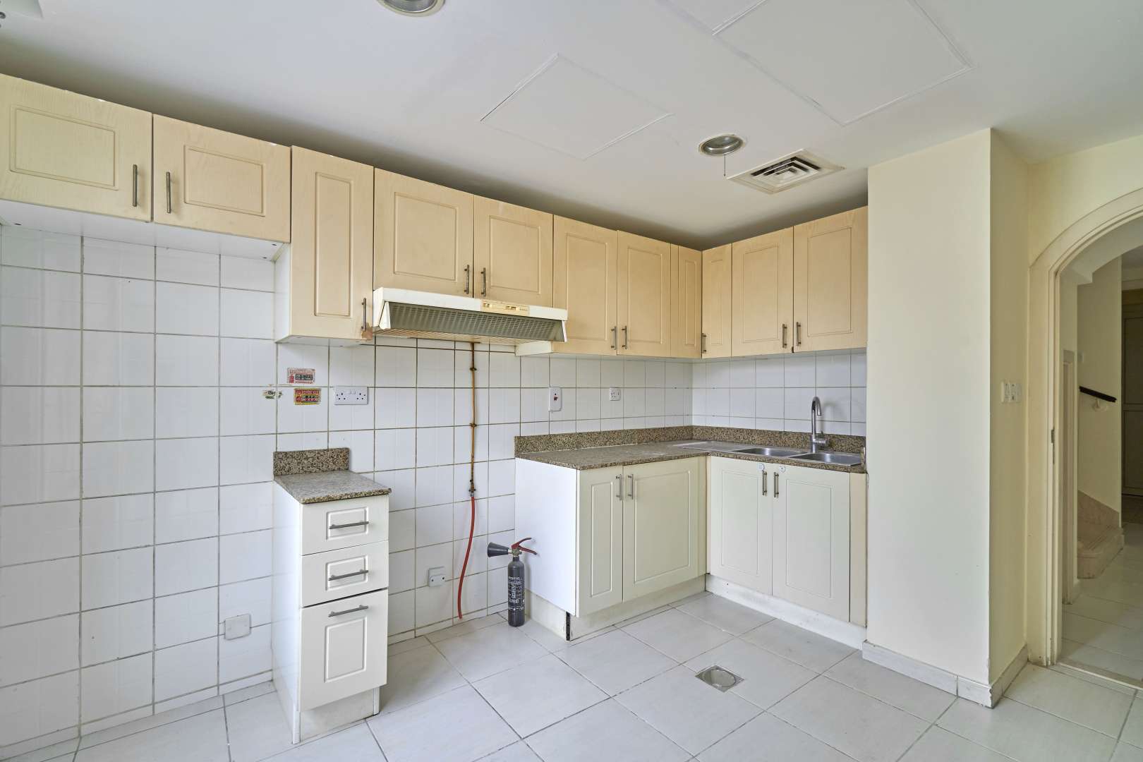 Bright bedroom with tiled floors and balcony access in The Springs villa, Emirates Living