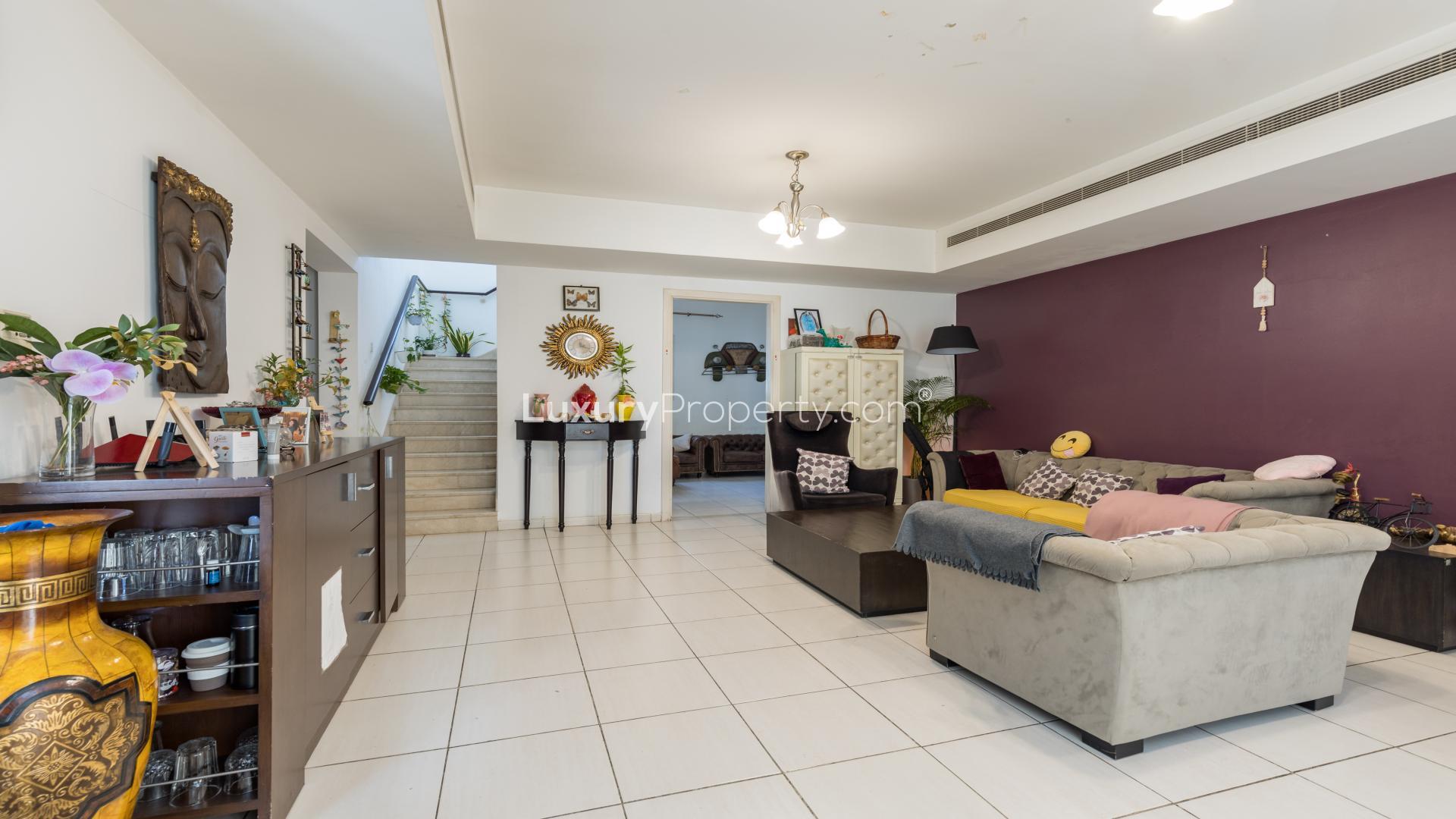 Backyard garden of Springs 3 villa for rent, featuring lush greenery and patio space