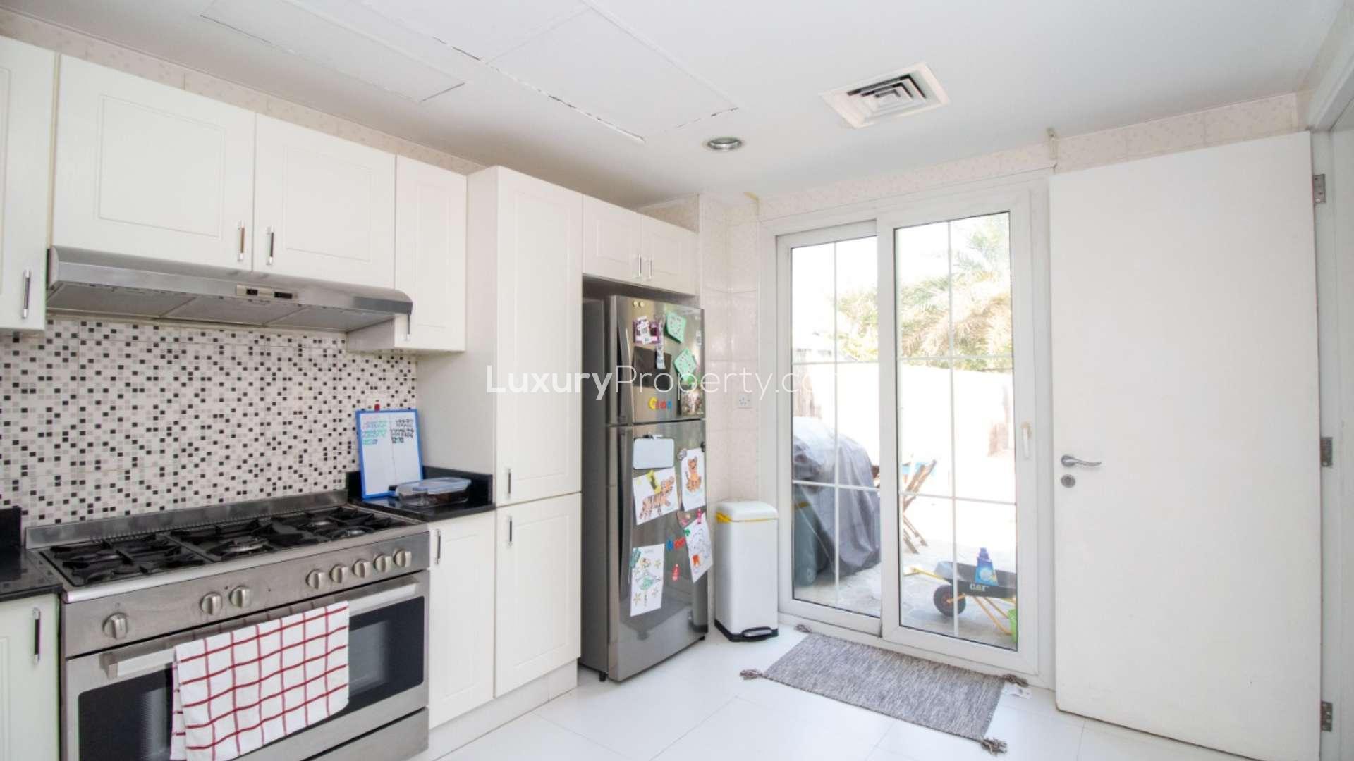 Corner plot villa garden with playground equipment in Springs 14 community, available for rent