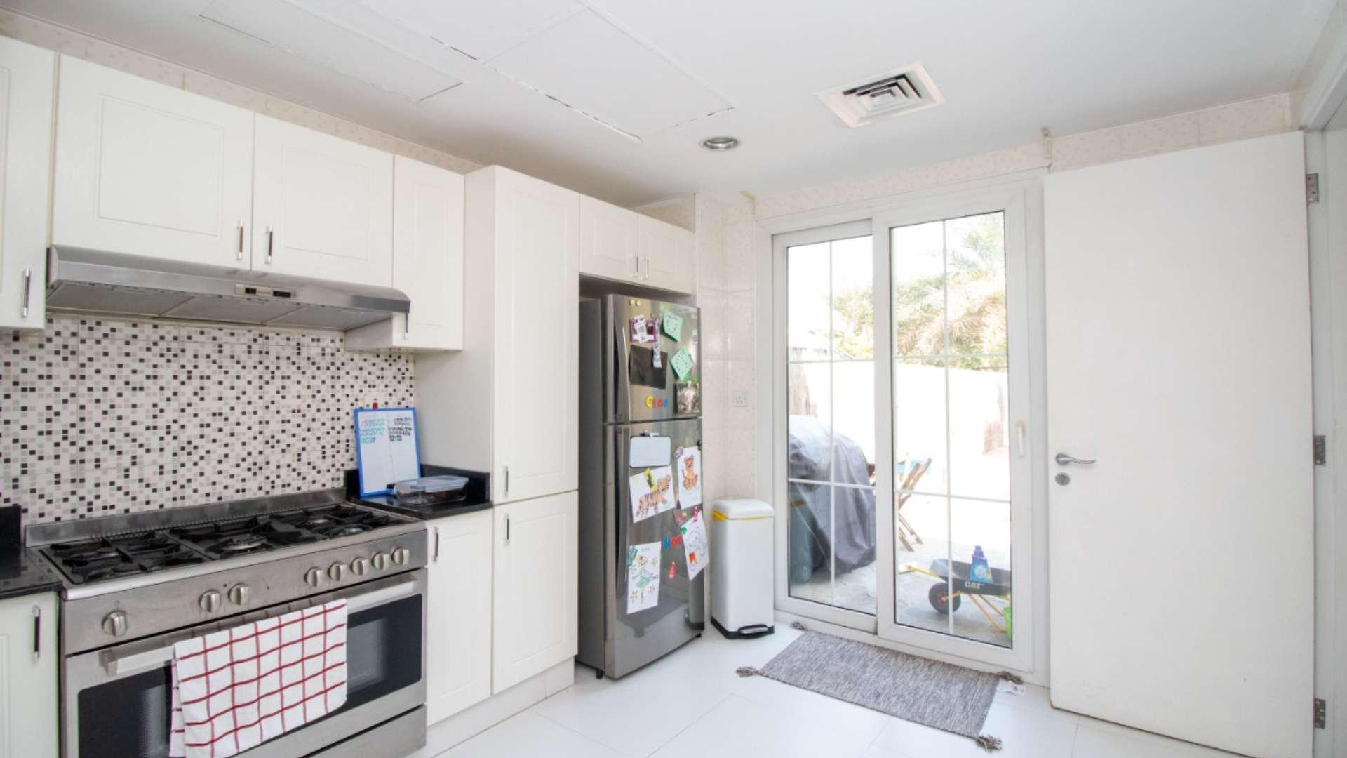 Corner plot villa garden with playground equipment in Springs 14 community, available for rent