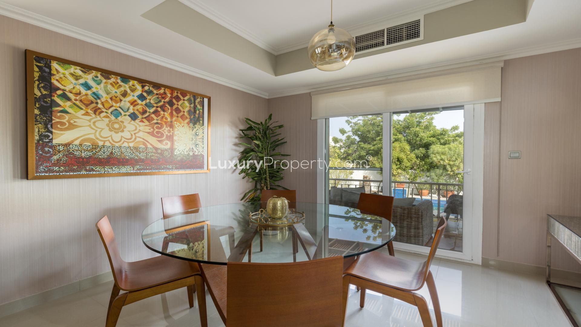 Fully furnished living room in upgraded villa, Springs 14, with modern decor and natural light