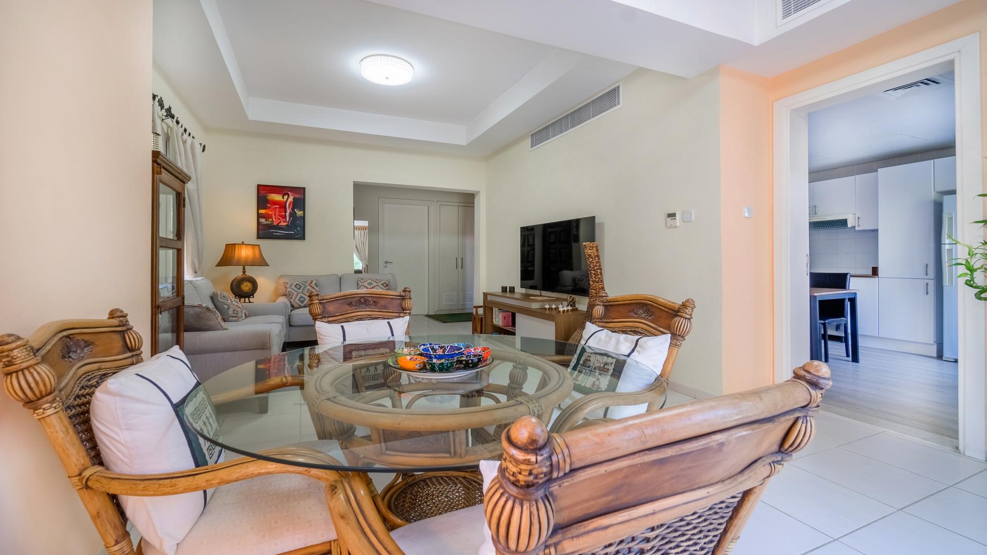 "Furnished villa living and dining area, The Springs, with elegant decor and natural light.",Semi-upgraded furnished villa in The Springs with elegant dining area and modern decor