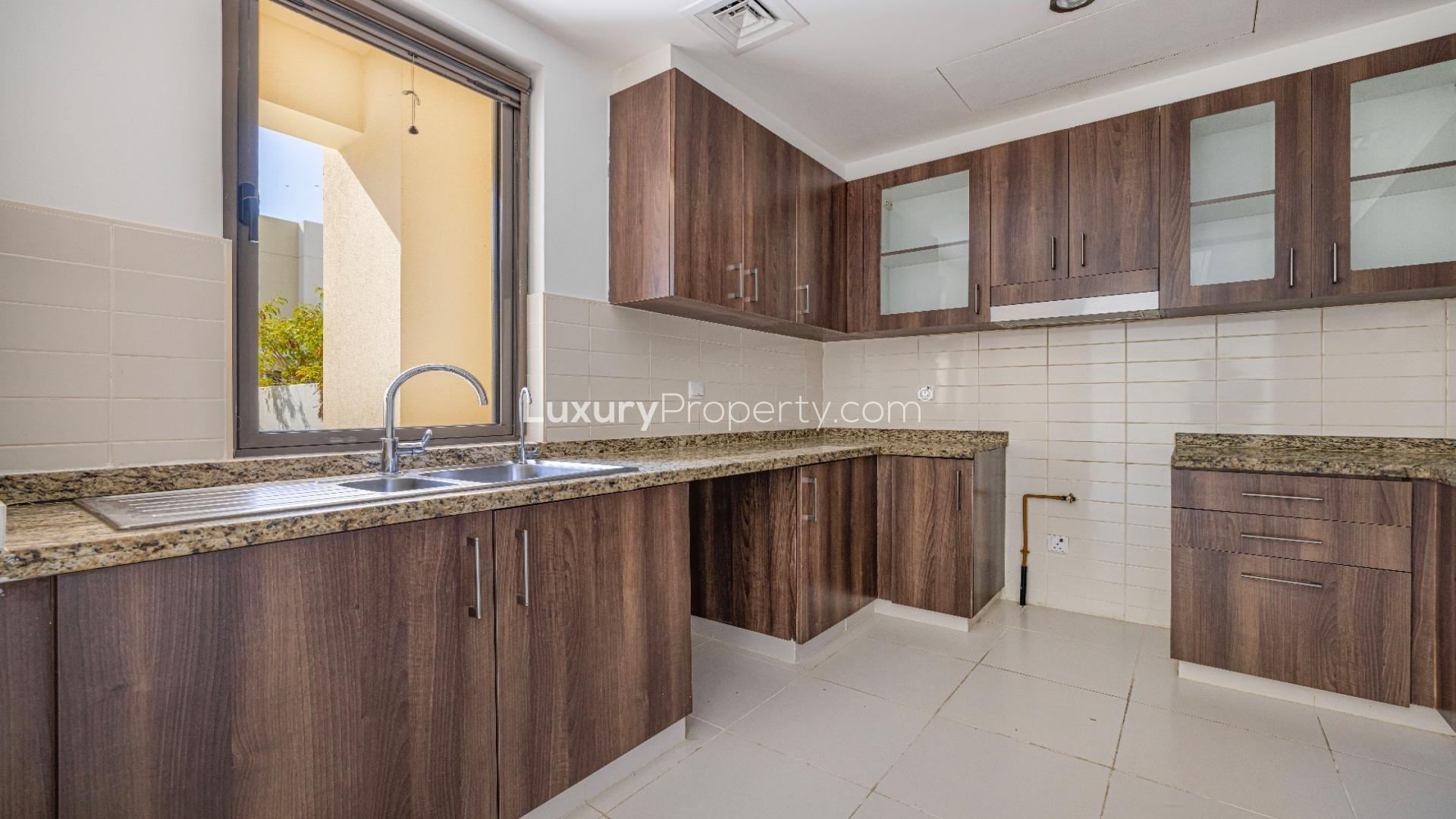 Bright living area with large windows in Mira Oasis villa, Reem community