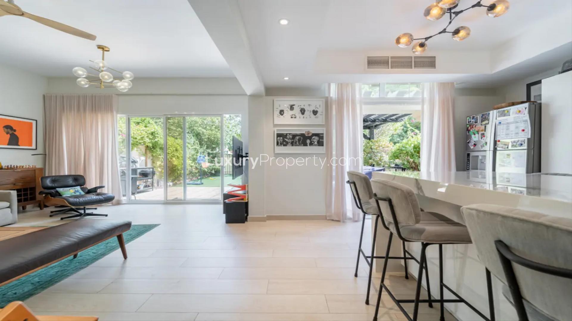 Beautifully landscaped backyard of Springs 15 villa with seating area and lush greenery