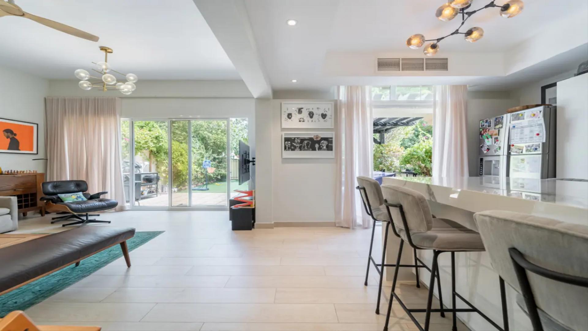 Beautifully landscaped backyard of Springs 15 villa with seating area and lush greenery