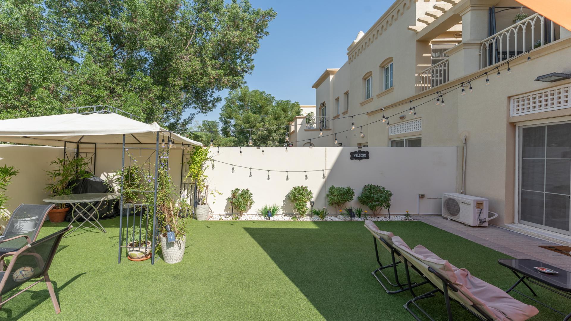Modern living room in 2-bedroom villa at The Springs with garden view and stylish decor