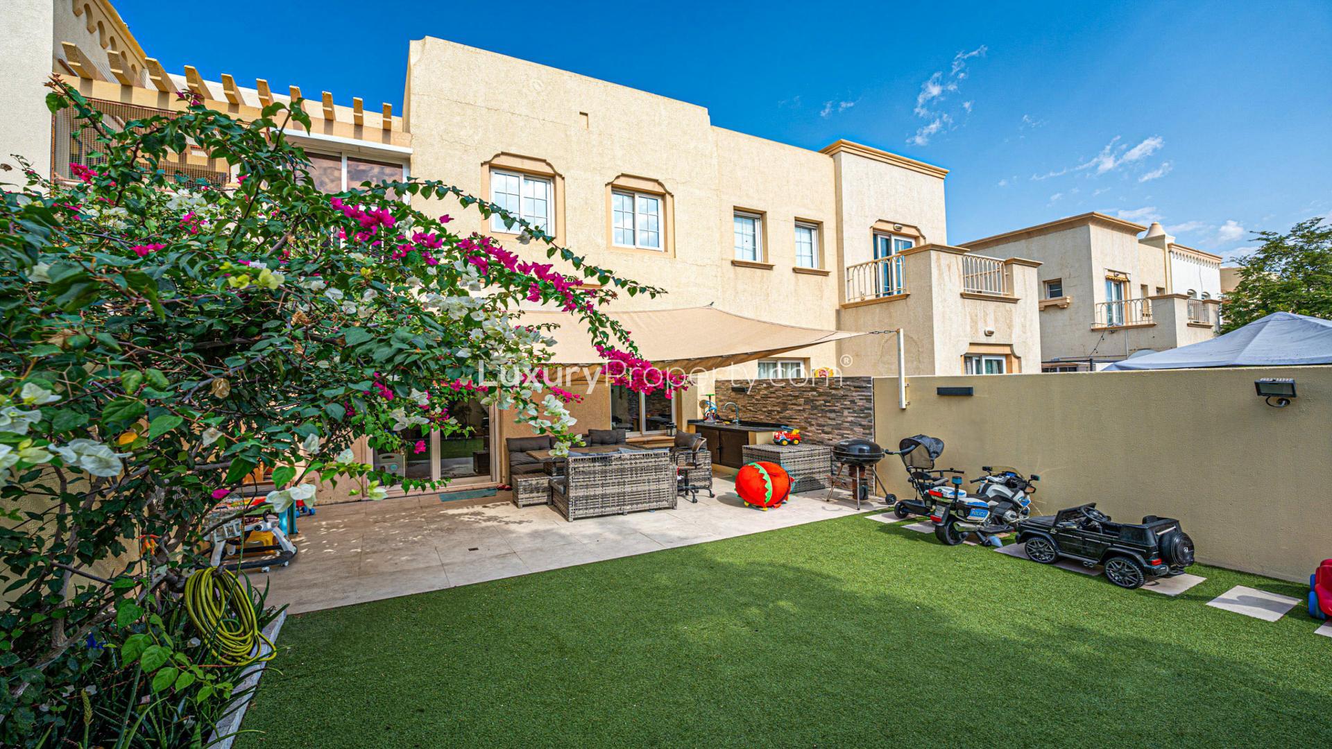 Modern living room in 2-bed luxe villa, Emirates Living, with garden view and elegant decor