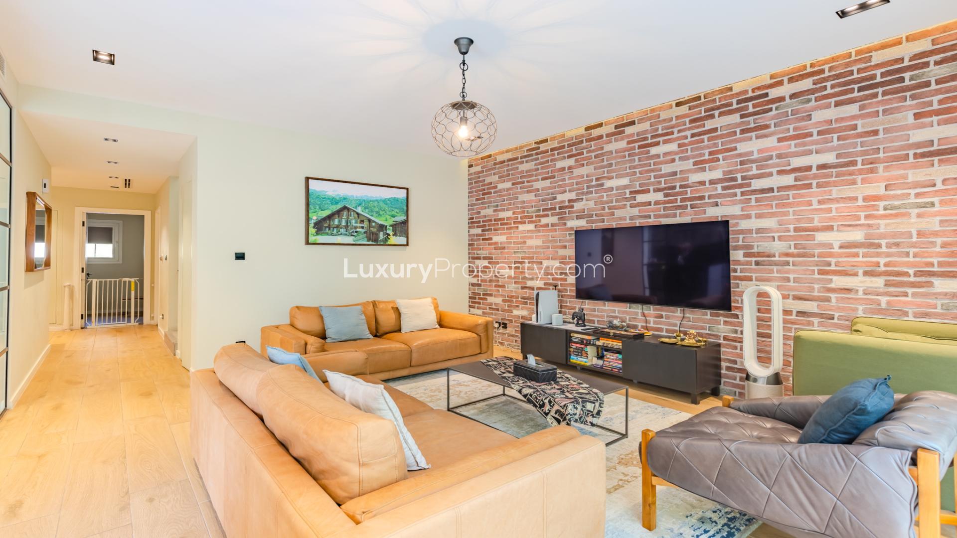 Upgraded villa living room with modern decor, large window view, The Springs 15