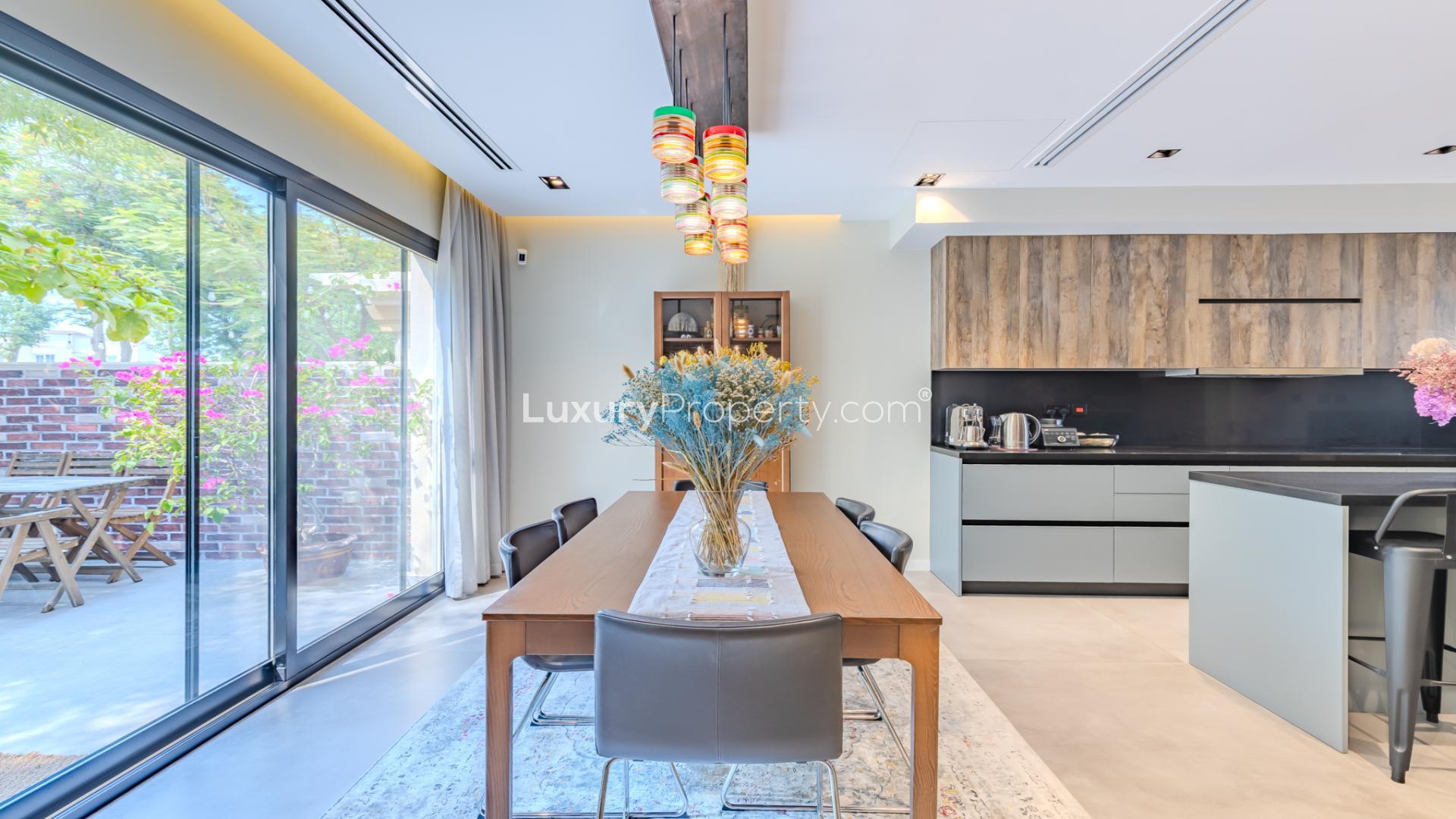 Modern living room in upgraded villa, Springs 15, featuring cozy sofas and stylish decor