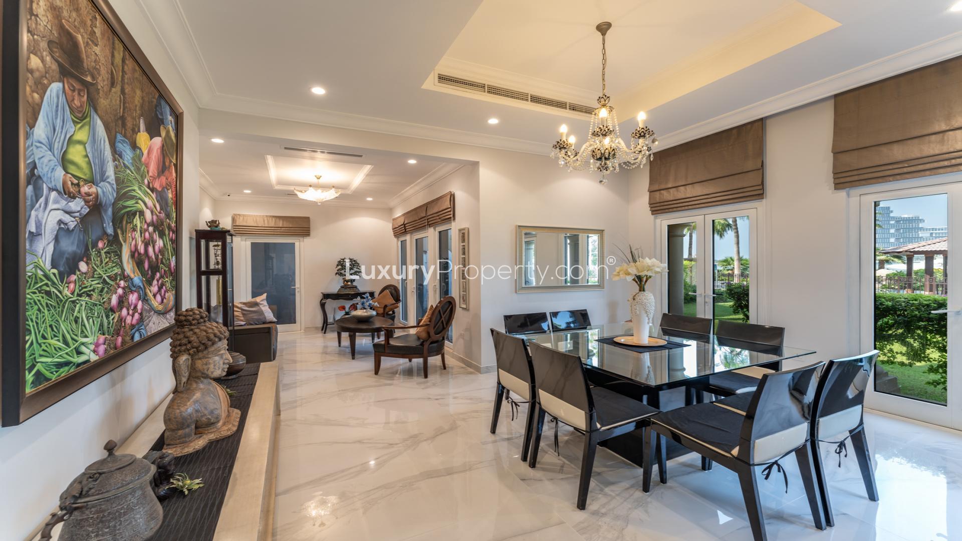 Exterior view of upgraded Canal Cove Villa with lush garden in Palm Jumeirah