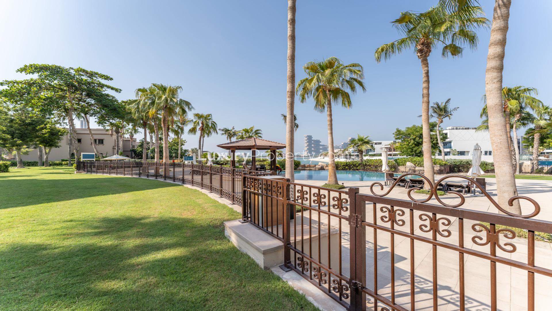 Luxurious living room in upgraded Canal Cove Villa, Palm Jumeirah, with elegant chandelier