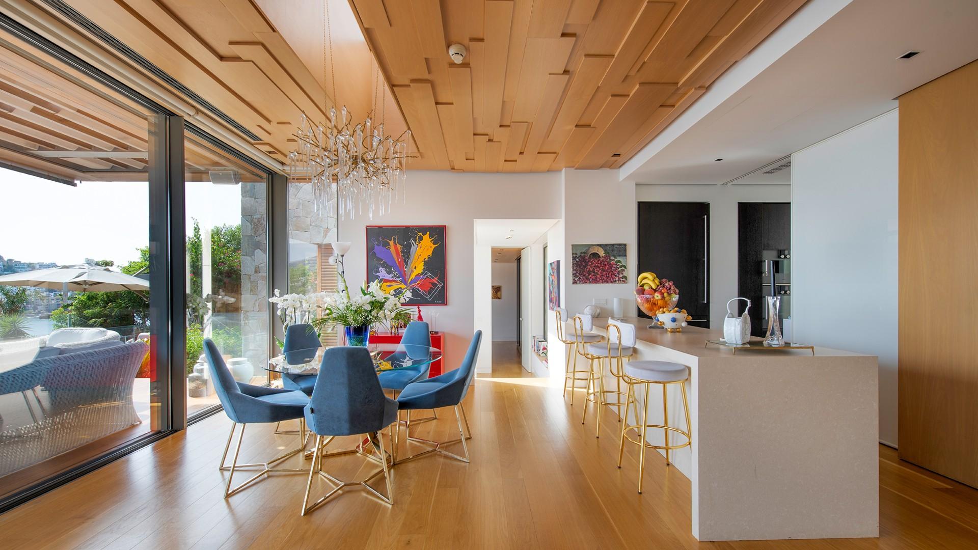 "Luxury kitchen and dining area in Ritz-Carlton Bodrum villa with open terrace views.","Luxury villa bedroom with terrace and sea view at The Ritz-Carlton Bodrum.",Luxury villa in The Ritz-Carlton Bodrum with open terraces and stunning sea views.