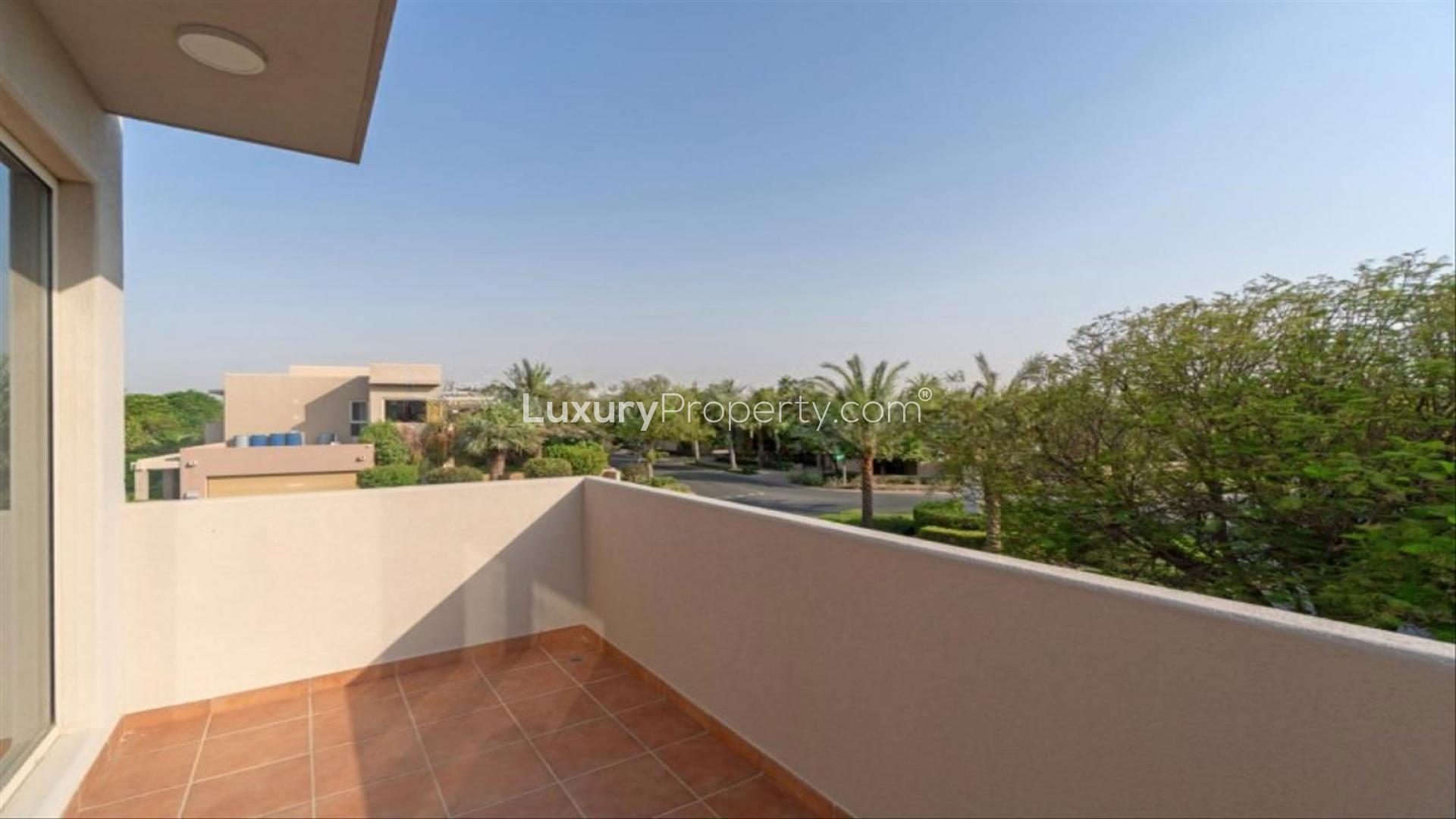 Modern villa interior with stylish decor, wooden staircase, and vibrant artwork in Saheel, Arabian Ranches
