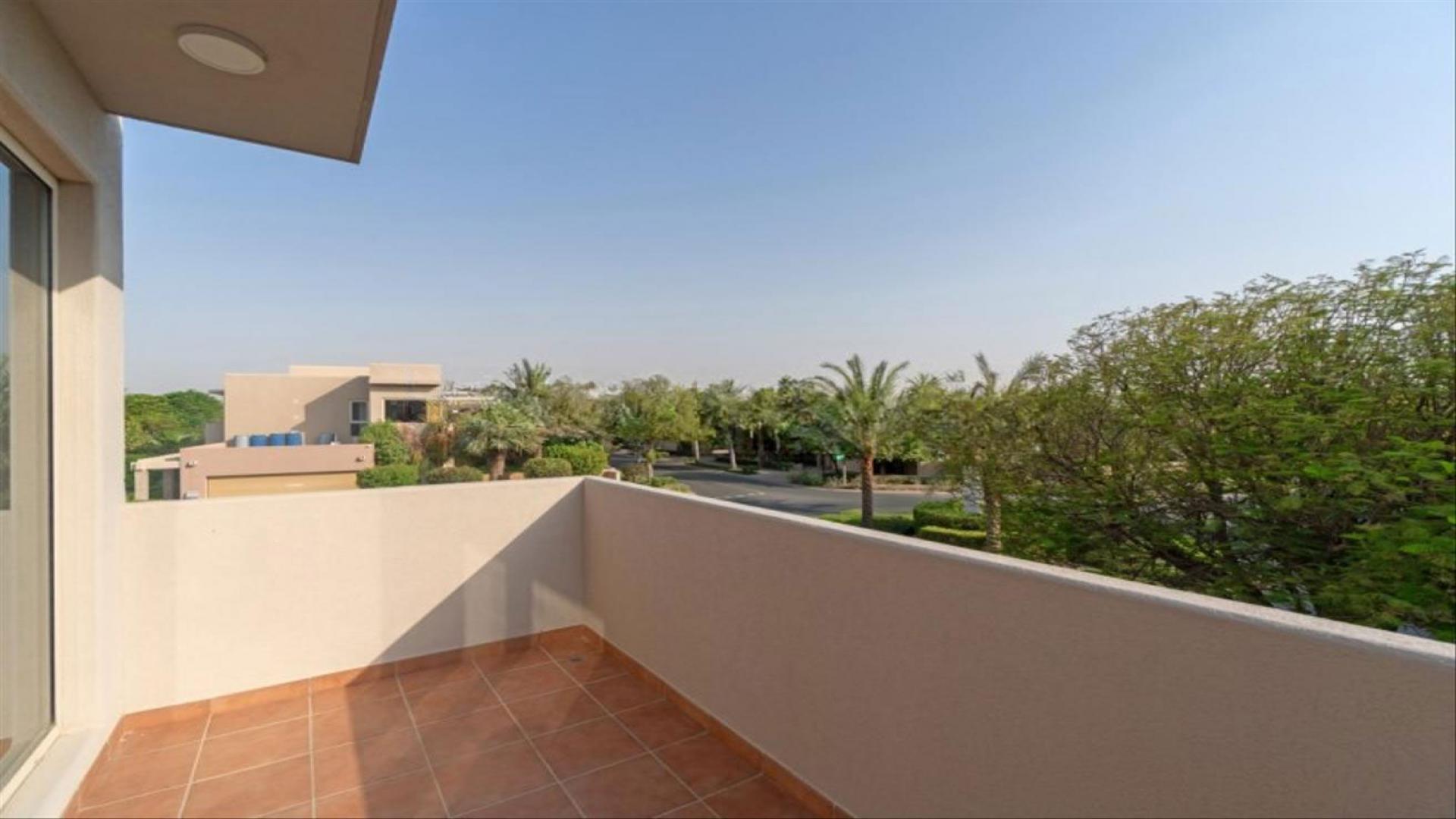 Modern villa interior with stylish decor, wooden staircase, and vibrant artwork in Saheel, Arabian Ranches