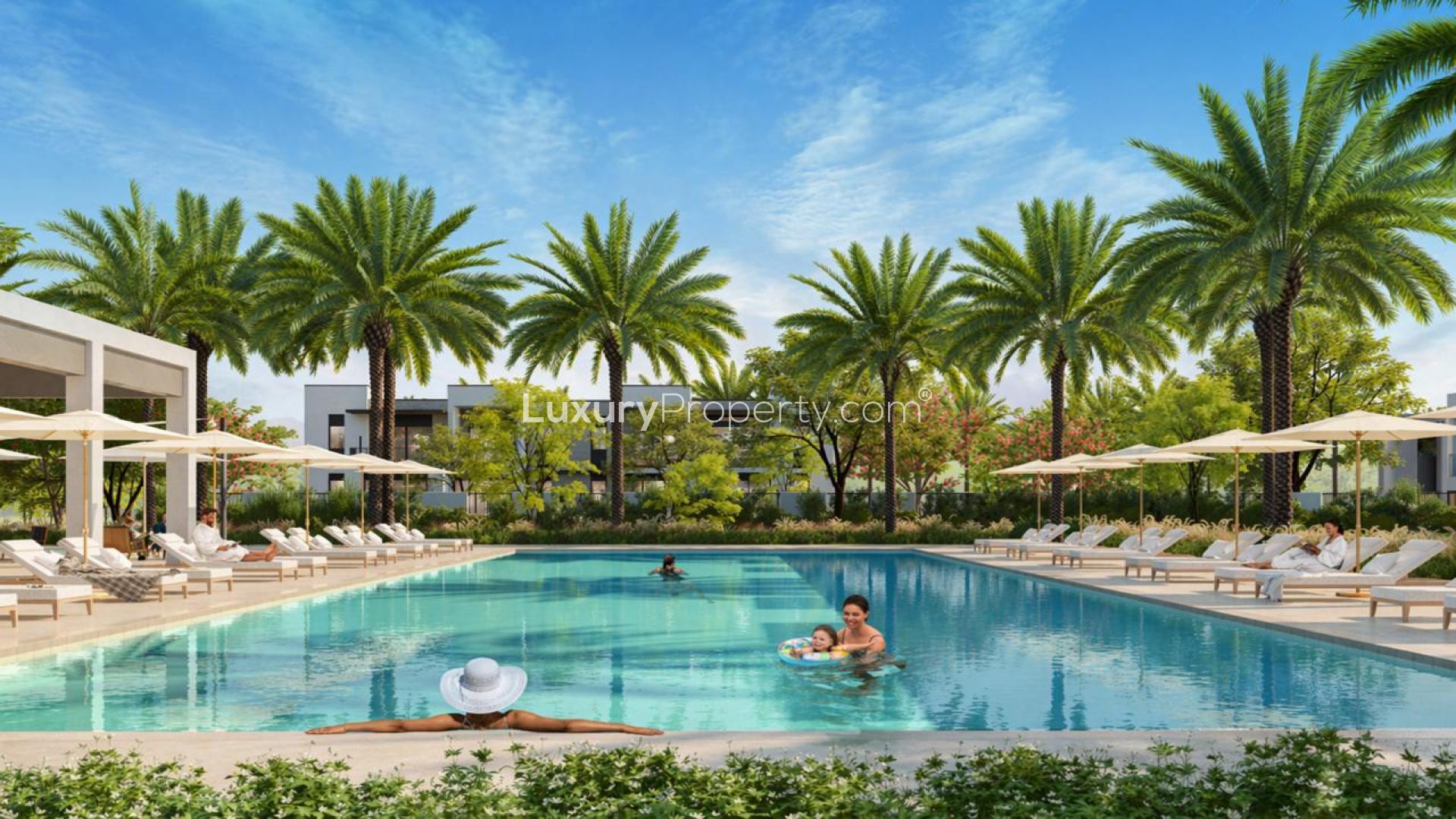 Modern villa exterior in Anya 2, Arabian Ranches 3, with lush landscaping and palm trees