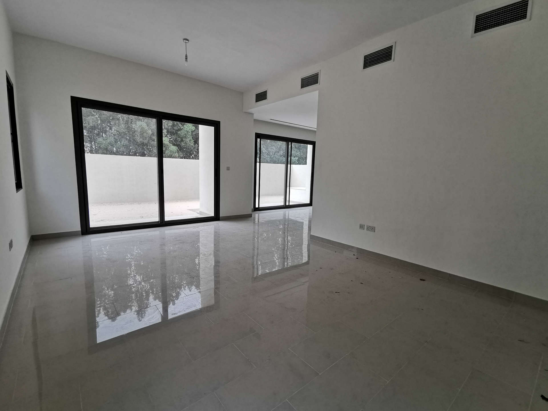 Modern bedroom with tiled floor and built-in wardrobe in Azalea Villa, Arabian Ranches 2