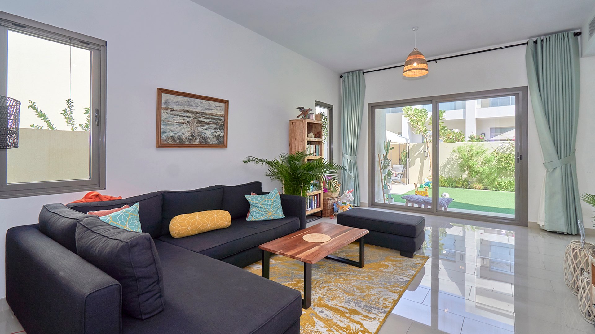Modern living room in Azalea villa, Arabian Ranches 2, with garden view
