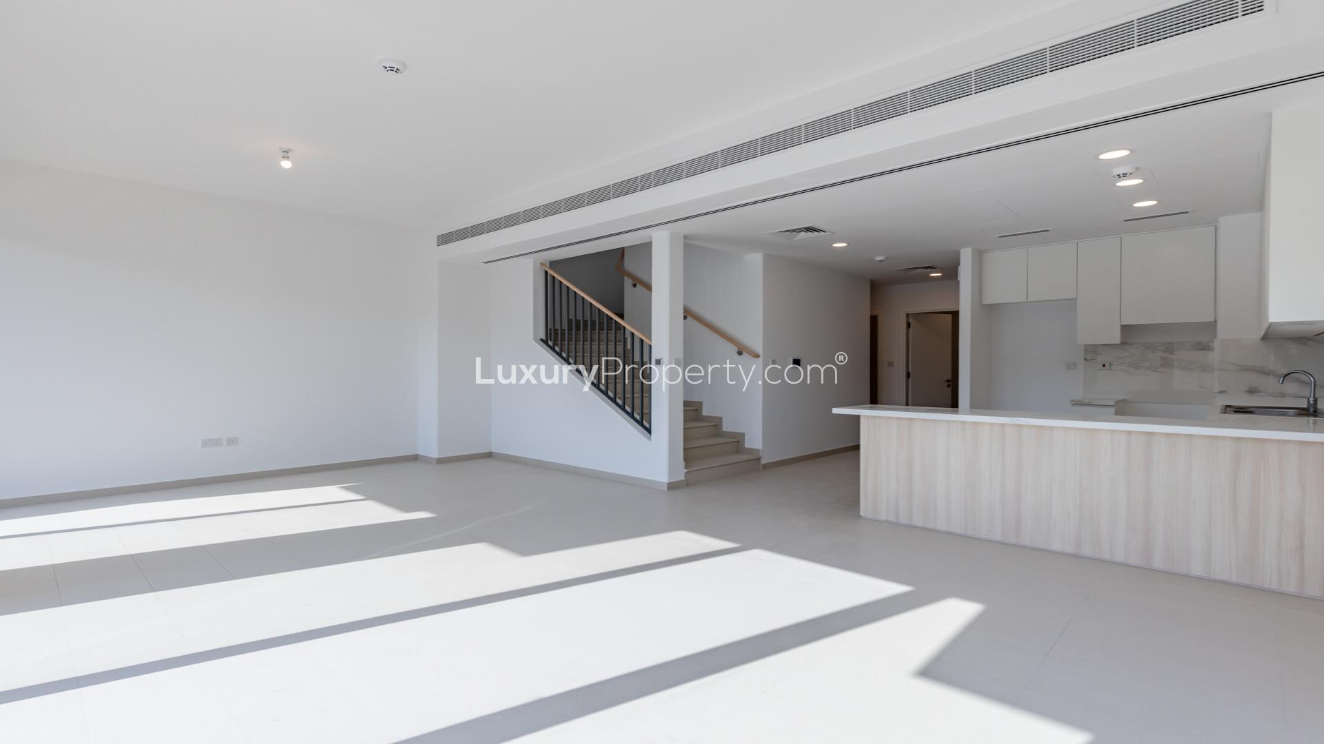 Townhouse in Cherrywoods, Dubai Land with modern pool and landscaped surroundings for sale