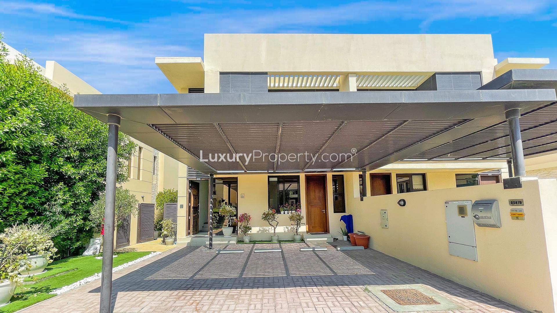 "Charming garden view of 3-bedroom villa for rent in Brookfield, Damac Hills.",Exterior view of 3-bedroom villa with garden in Brookfield, Damac Hills for rent