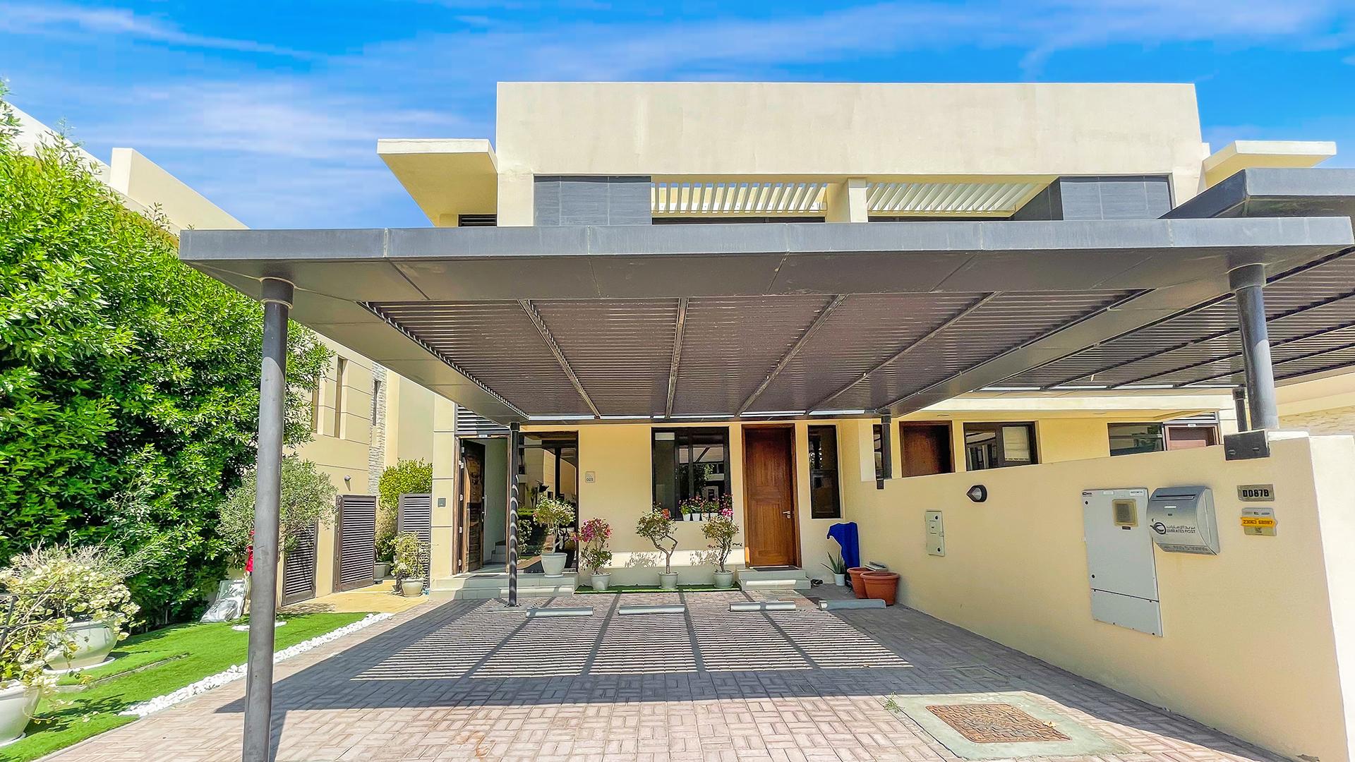 "Charming garden view of 3-bedroom villa for rent in Brookfield, Damac Hills.",Exterior view of 3-bedroom villa with garden in Brookfield, Damac Hills for rent